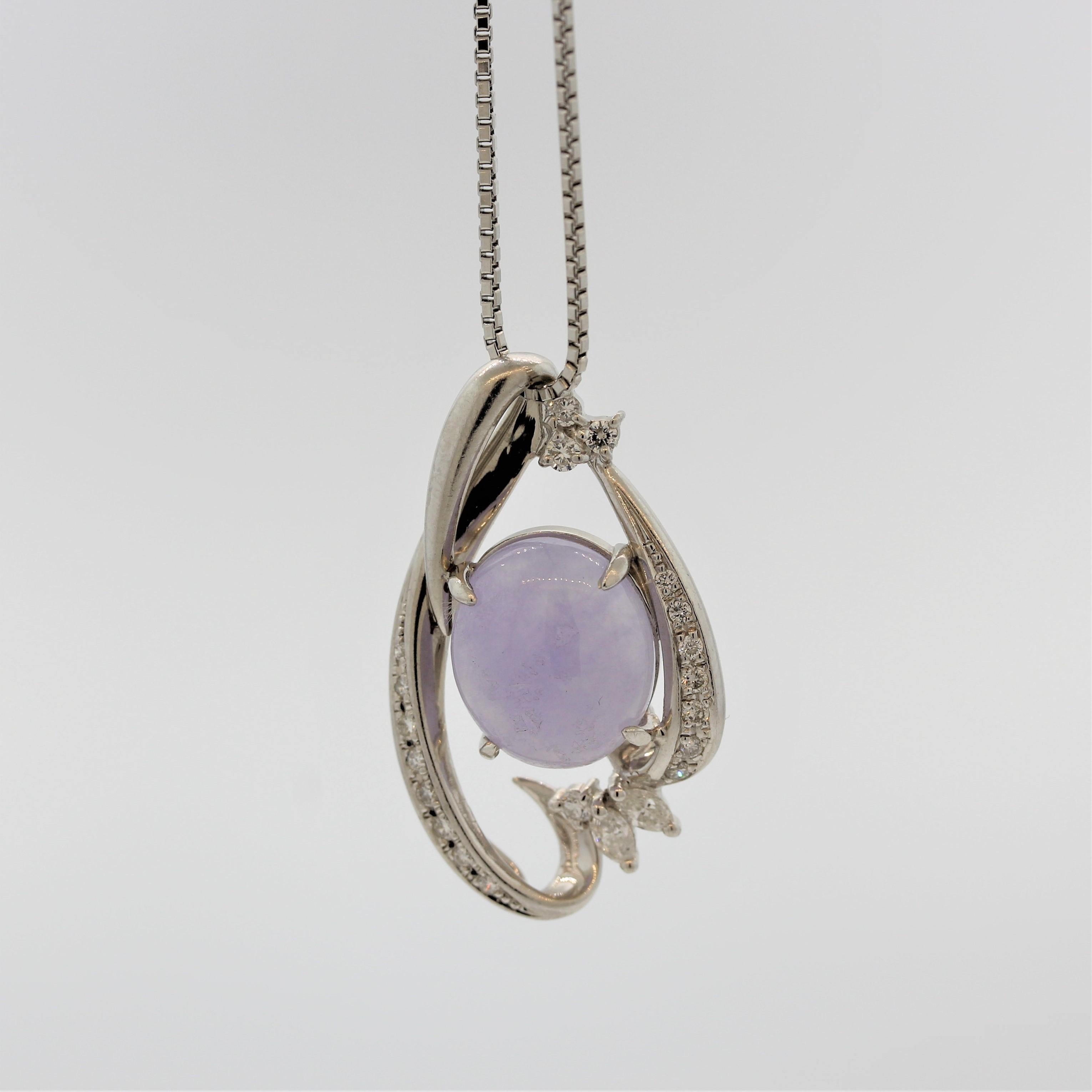 A mesmerizing piece of natural lavender jade takes center stage. It weighs 7.52 carats and appears to glow from its interior, something typical of only fine pieces of jade. It Is accented by 0.45 carats of round brilliant and marquise shaped