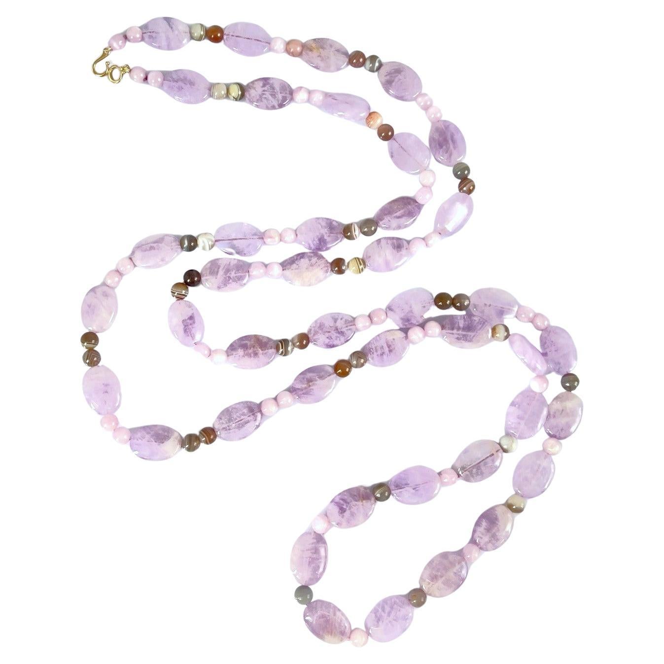 This wonderfully versatile necklace features elegant rose de France amethyst beads combined with pinkish lavender kunzite and beautifully banded smoky quartz! The round kunzite beads complement the delicate purple shade of the oval amethyst beads,