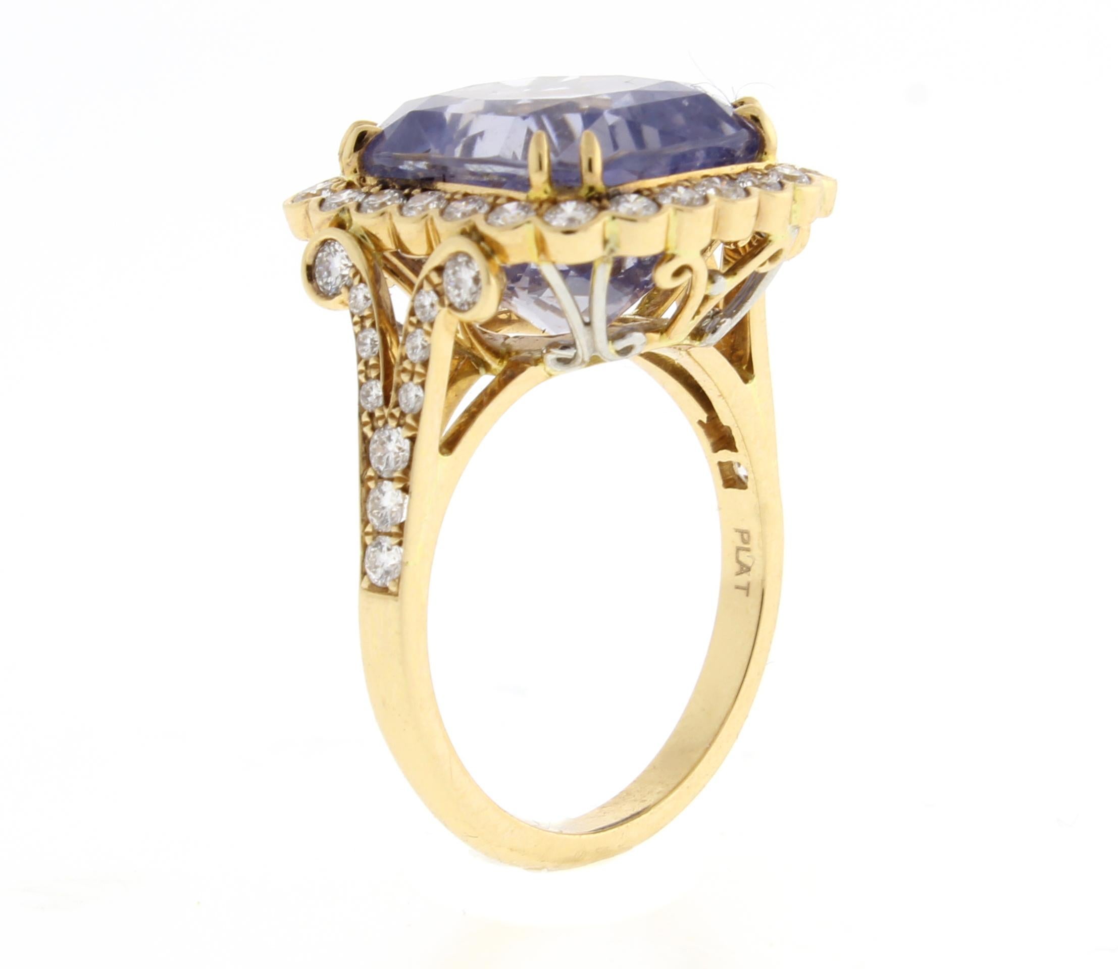 This ring features a non-heated Ceylon lavender sapphire that weighs 11.92 carats. The sapphire is surrounded by 46 bead-set round brilliant diamonds that have a total weight of .81 carats. The ring is 18 karat peach gold and is handmade by