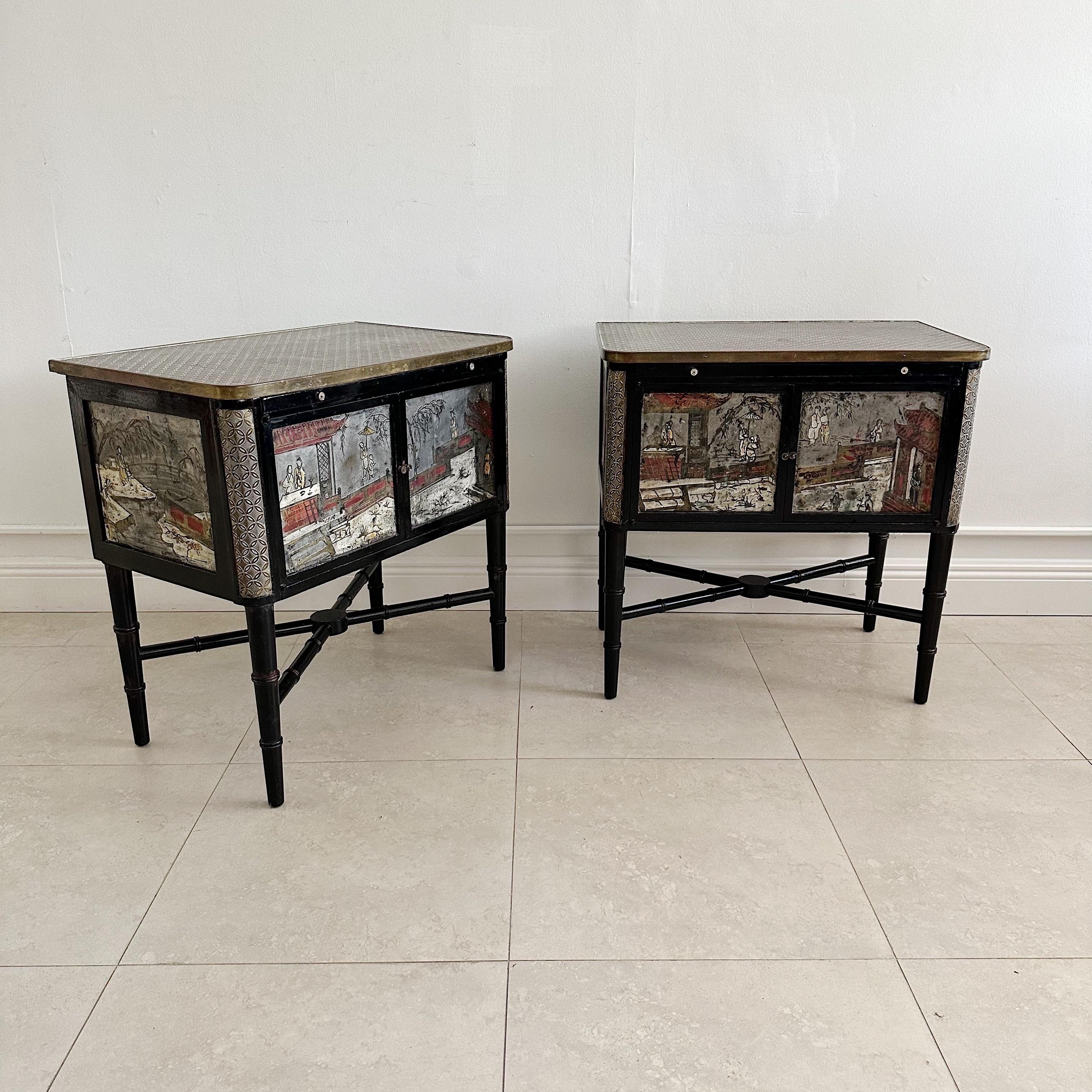 Laverne style night tables from the 1960s. Metal and wood faux bamboo. Different Chinese imagery on each panel. 2 doors and slide out writing surface. Shows nice vintage patina.
