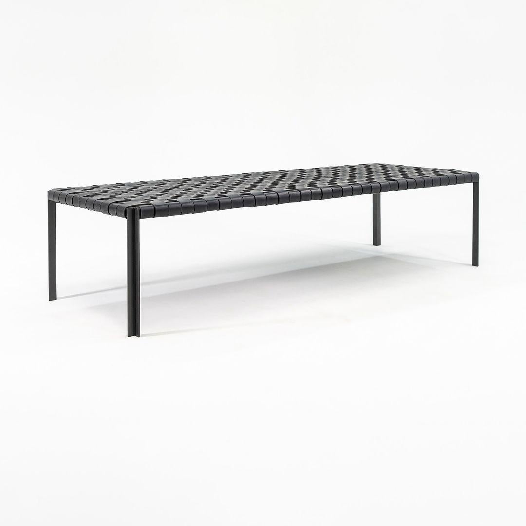 This is a TG-18 Long Woven Leather Bench in black leather with a blackened bronze frame produced by Gratz Industries. The bench was designed was designed by Katavolos, Littell and Kelley in 1952 as part of the original Laverne Collection produced by