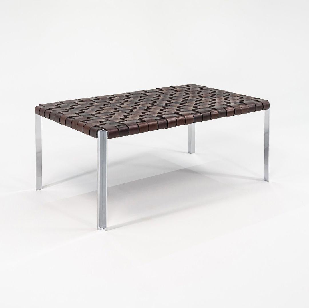 This is a TG-18 Small Woven Leather Bench in brown leather with a polished chrome frame produced by Gratz Industries. The bench was designed was designed by Katavolos, Littell and Kelley in 1952 as part of the original Laverne Collection produced by