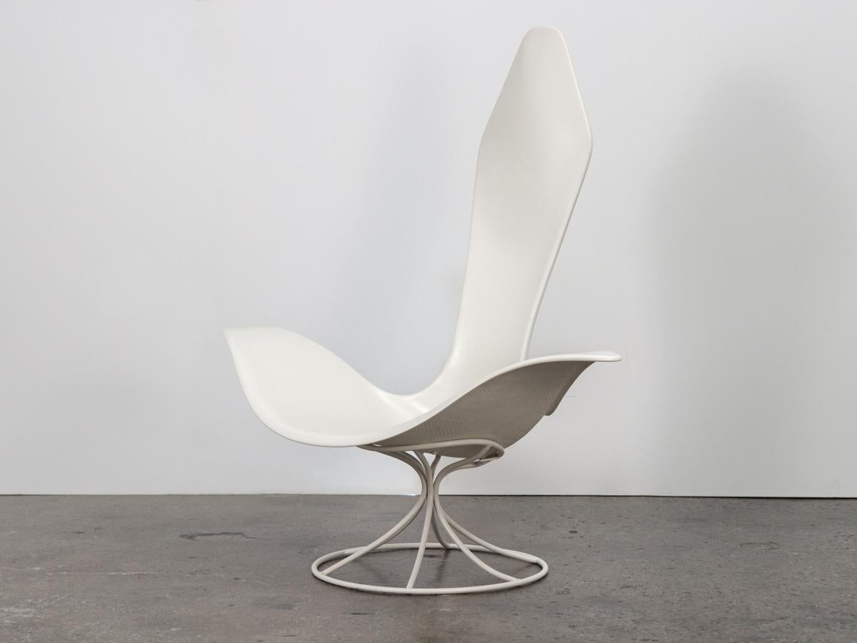 Sculptural yet functional lounge chair designed by artist Erwine and Estelle Laverne and produced by Laverne International. The molded fiberglass shell seat supported by an enameled metal rod base. Our rare example is in Fine restored condition,