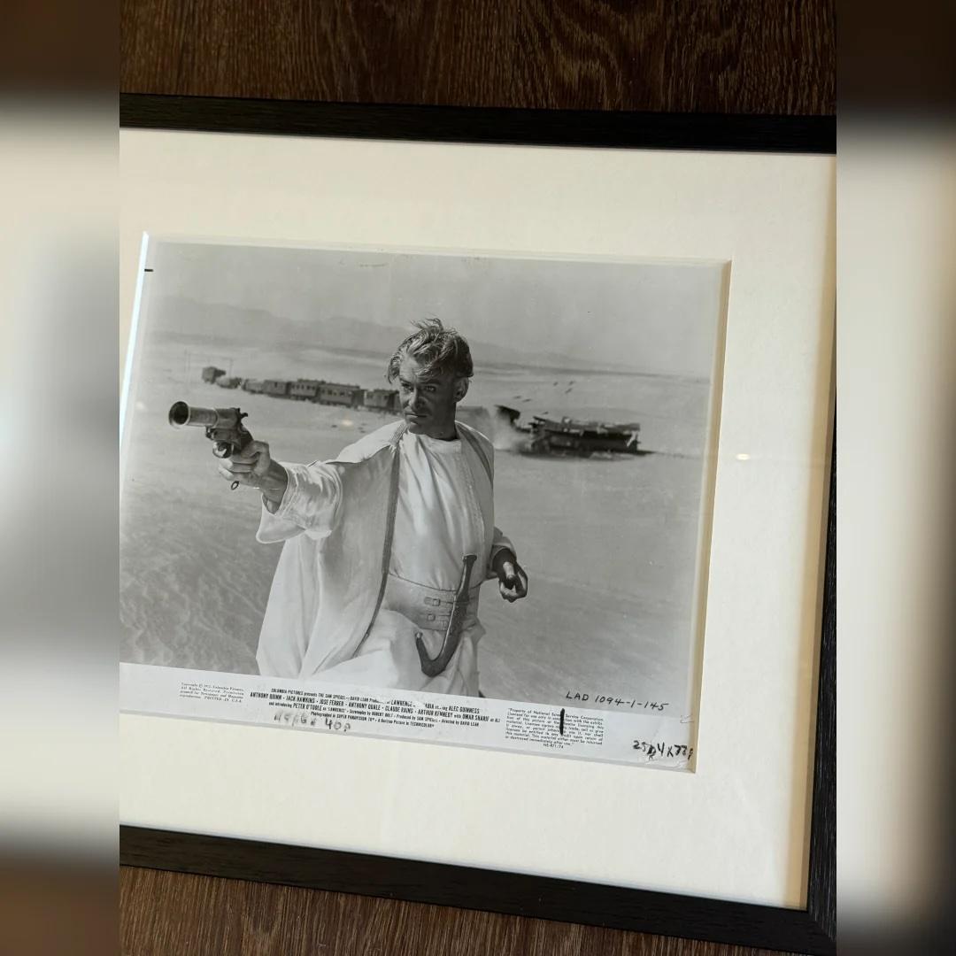 Lawrence Of Arabia (1971r) - FRAMED
Photo Still (8 X 10 Inches)

Original photo still.

A powerful original press still from the 1971 Columbia Pictures re-release of Lawrence of Arabia, featuring Peter O’Toole as T.E. Lawrence in full desert