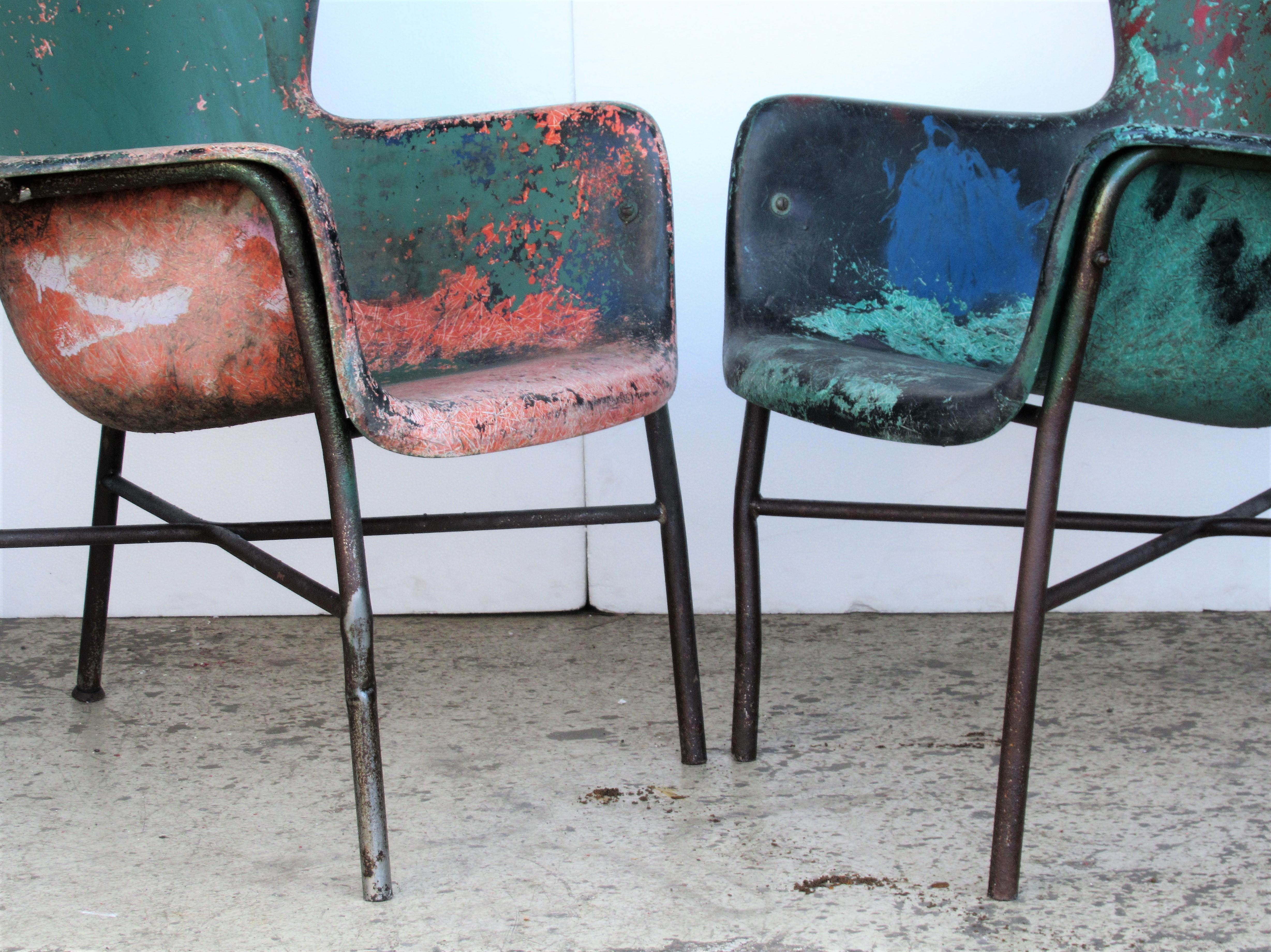 1950s fiberglass wing chairs with tubular metal X bases by Lawrence Peabody in eye dazzling beautifully aged old worn artist pallet style painted surface. Great looking as found art furniture. See all pictures.