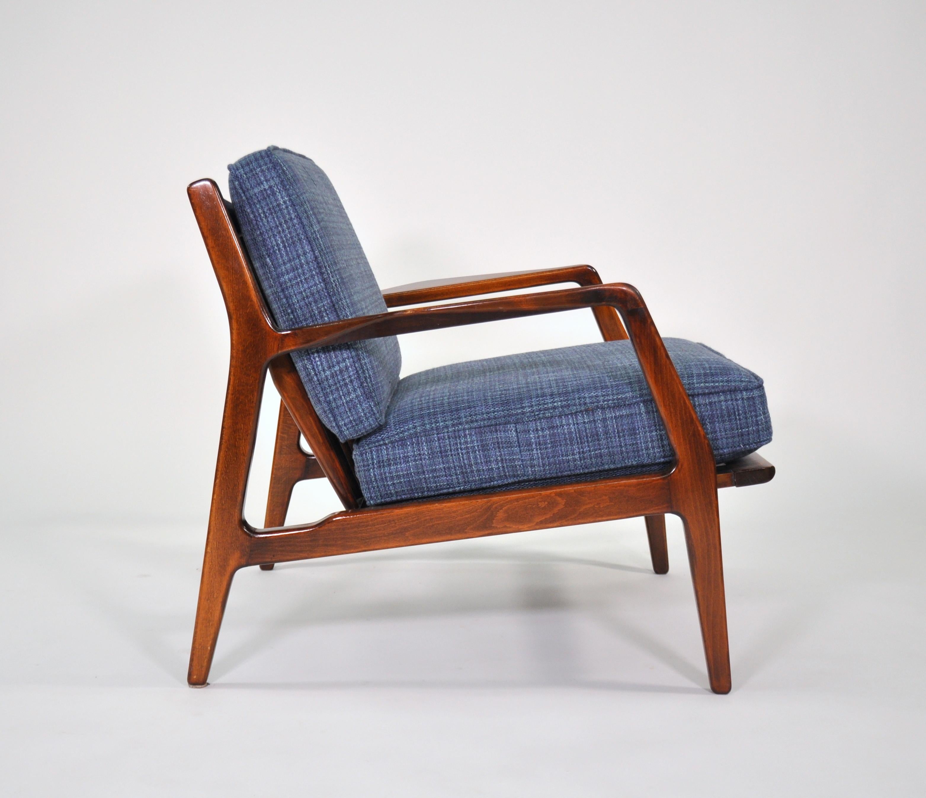 A vintage Mid-Century Modern easy chair, designed by Lawrence Peabody and manufactured in Denmark by Selig. The slatted back armchair has sculptural lines that make it stunning from all angles. The removable cushions are covered in a navy blue,