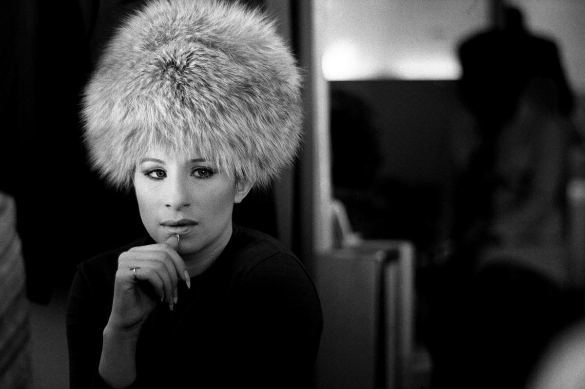 'Barbara Streisand, 1969' by American photographer, Lawrence Schiller. Digital pigment, Ed. 9/35. Image: 13 x 19 in. / Paper: 16 x 20 in. This black and white photograph features Barbara Streisand traveling from the US to England for filming at the
