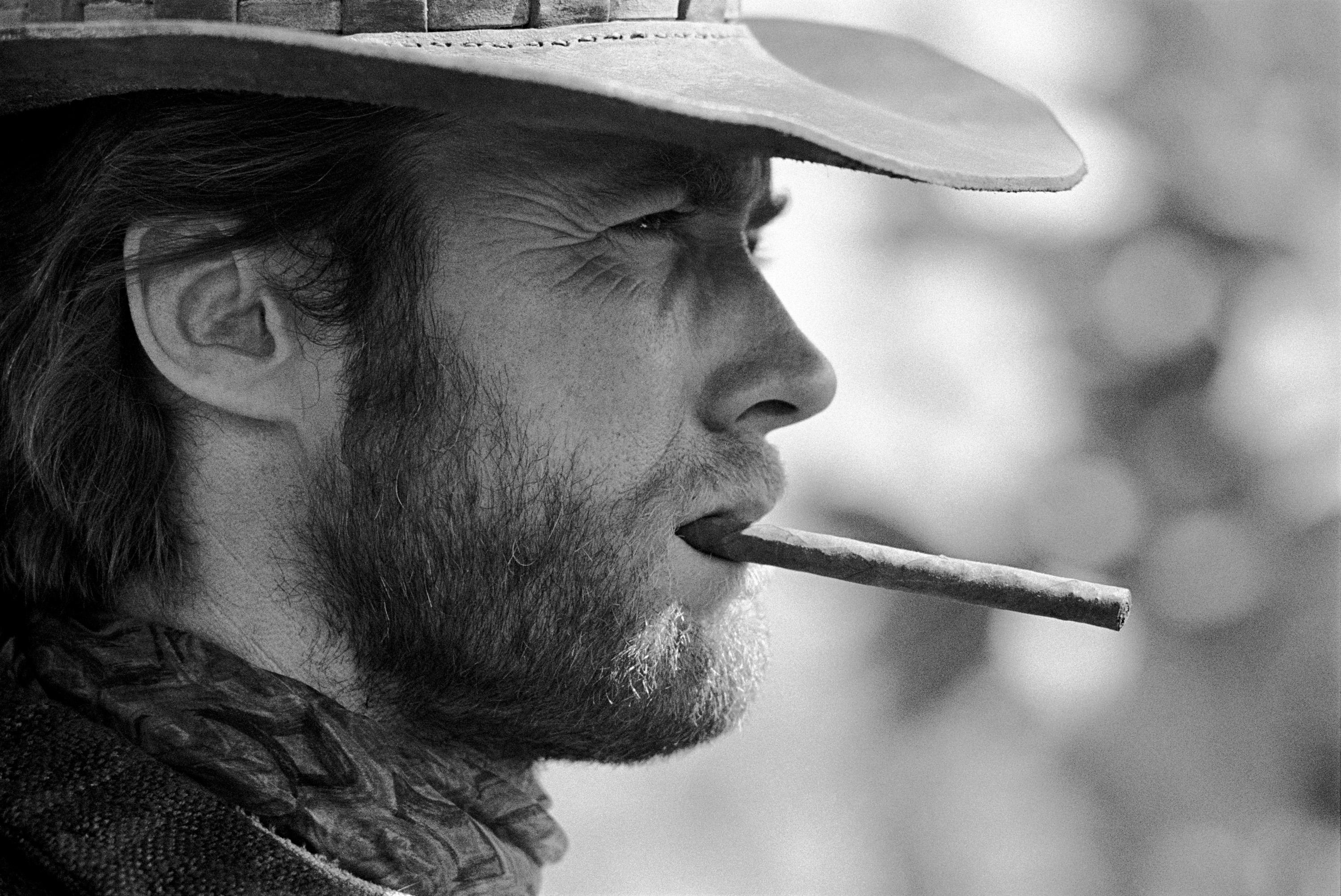 'Clint Eastwood, 1970' by American photographer, Lawrence Schiller. Archival digital print, EP 3/5. Image: 12.5 x 19 in. / Paper: 16 x 20 in. From the set of the movie 'Two Mules for Sister Sara' this black and white photograph features a side