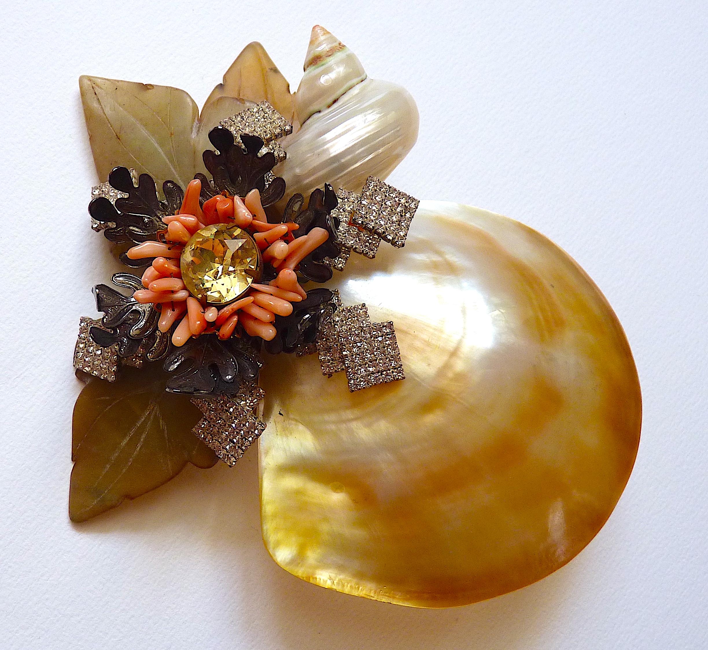 This is a Lawrence Vrba oversize Brooch made of oyster shell, sea shells, Glass Crystal and Poured Glass Beads, Vintage from the 1980s.
Vrba designed under his own name after working for famed American jewelry designer Miriam Haskell. 

Signed