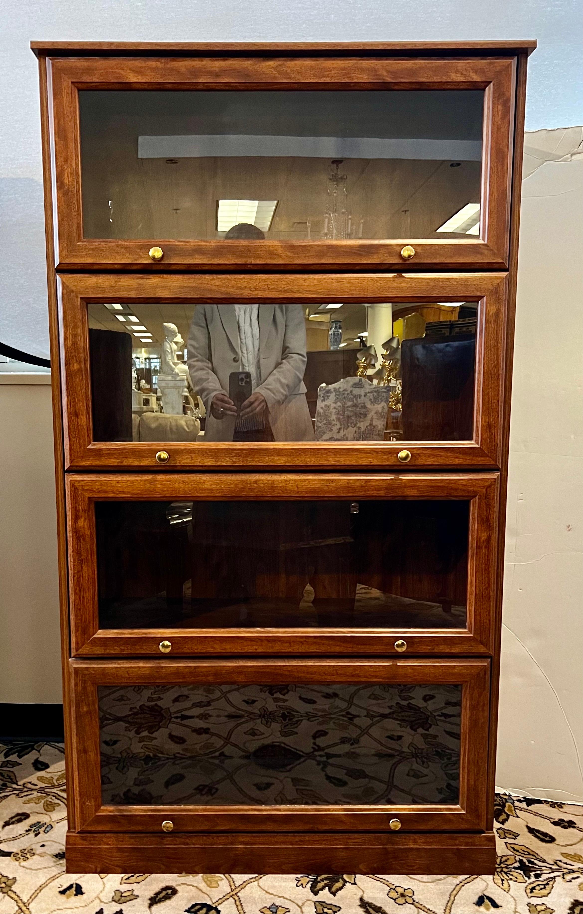 Tall barrister bookcase with four shelves that have glass doors that pull up and can be pushed inside like a true lawyers/barrister bookcase.  All over oak veneer finish.  This one does not separate into pieces like some othe older models do.