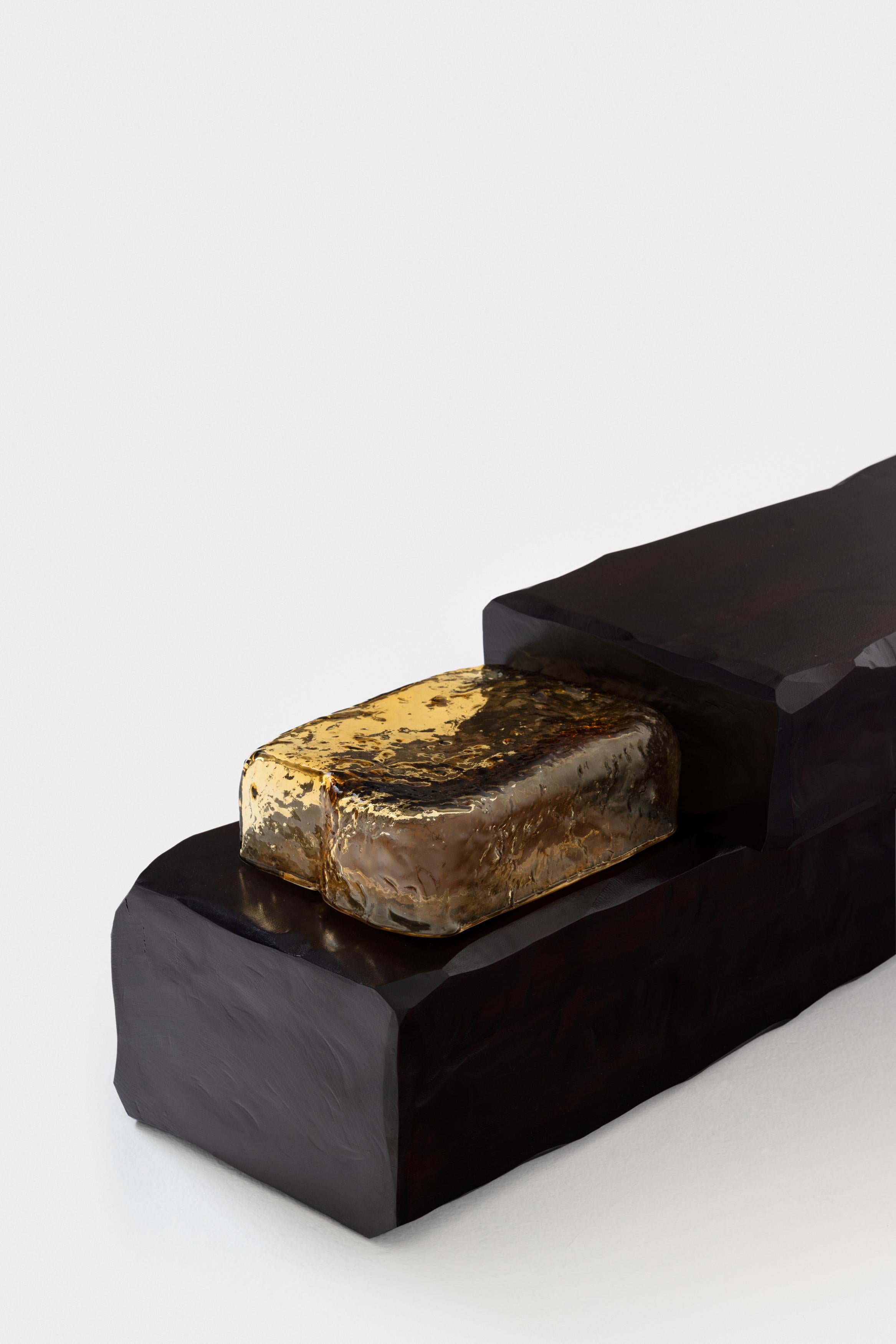 In the Sculptural Bench, carved out of wood, layers are applied in finishing
phase, where impregnation of deep reddish-black pigment and brushed
lacquer layer over layer gives its intensity on the work. Here, with each layer
brushed by hand, the