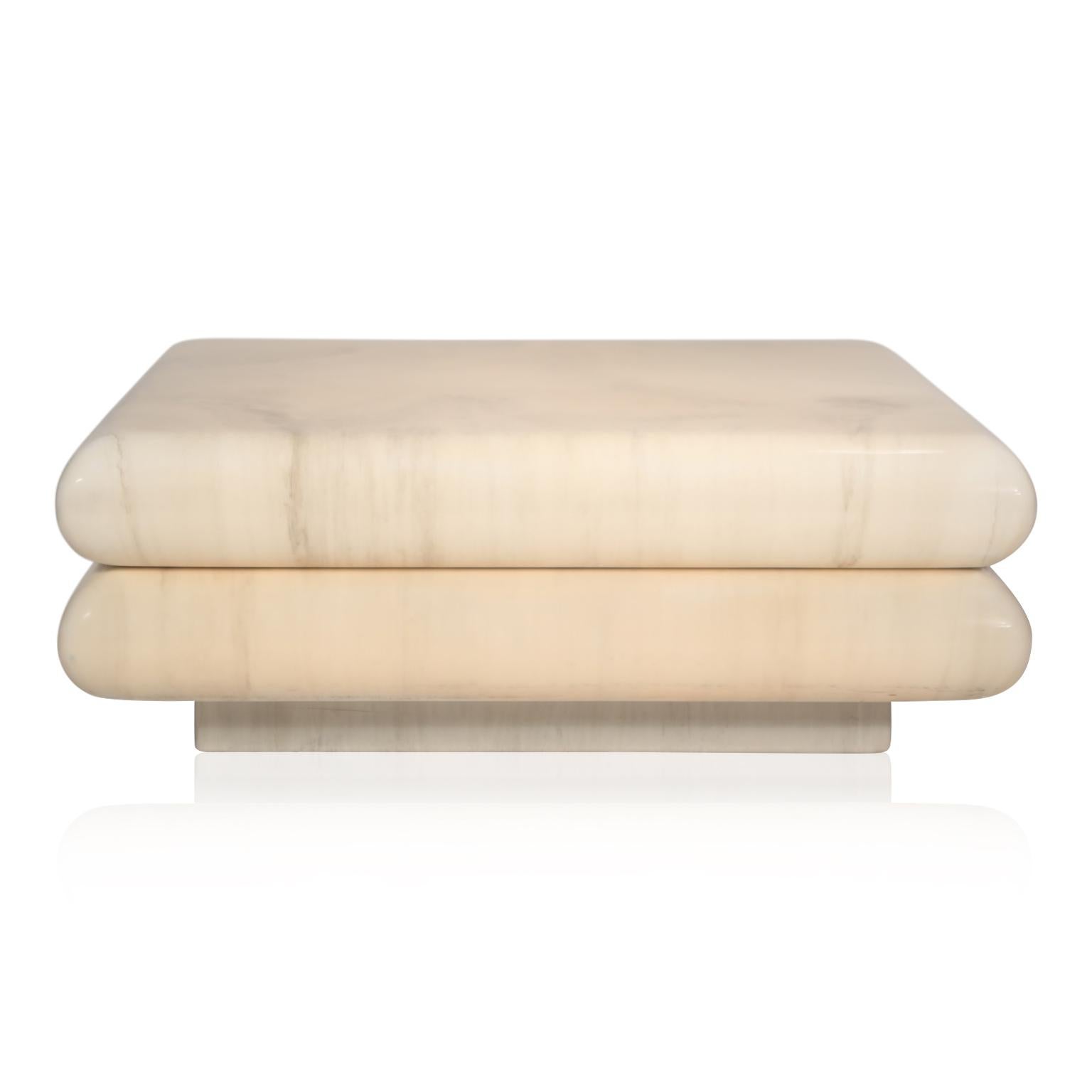 This layered coffee table floats on a plinth base and is covered in sumptuous lacquered goatskin. The goatskin color and veining is remarkable, a nice soft beige / tan color with grey veining which resembles marble and is so designer on-trend. The