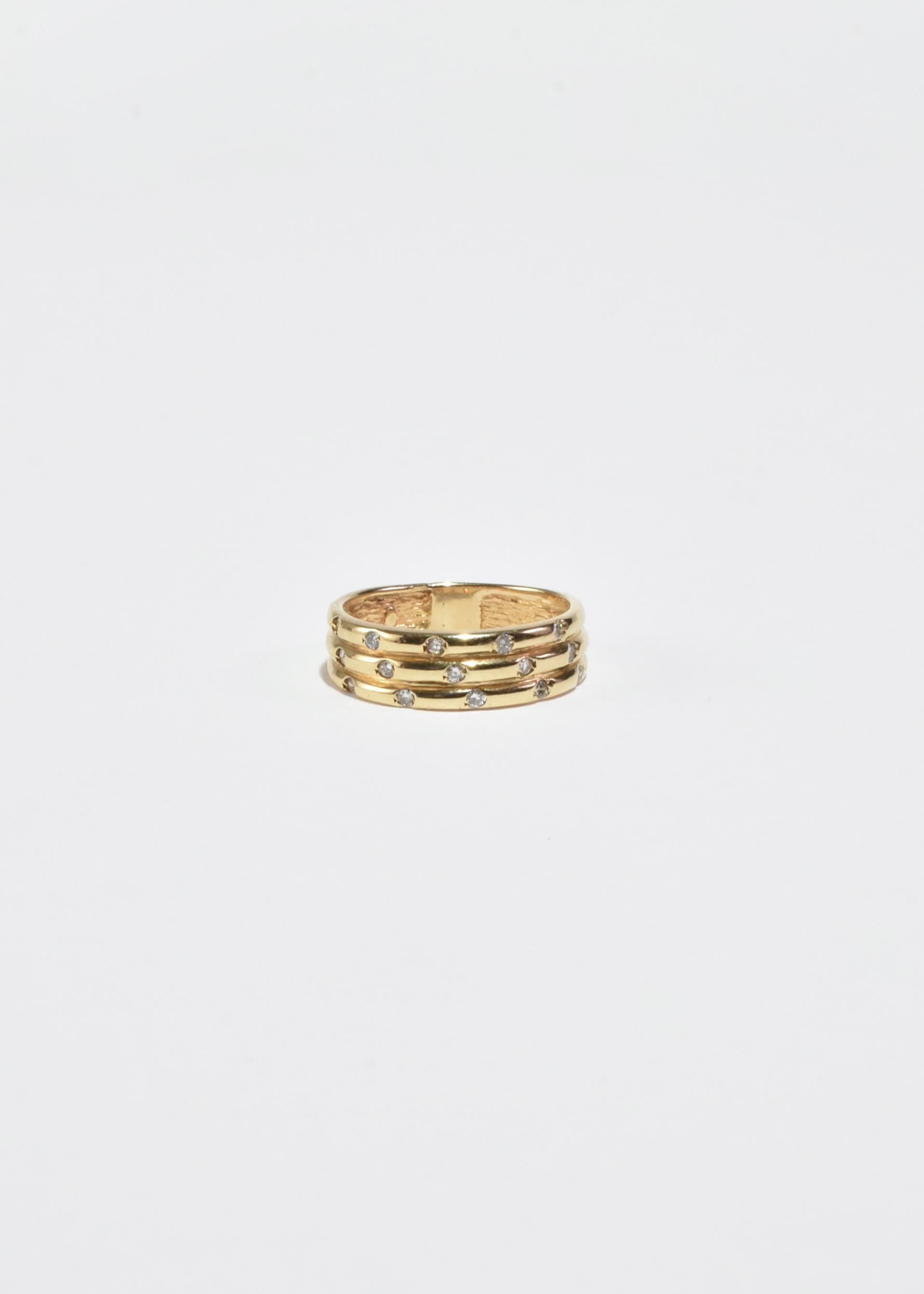 Stunning vintage gold ring with layered detail and fifteen faceted diamonds.

Material: 14k gold, diamond.