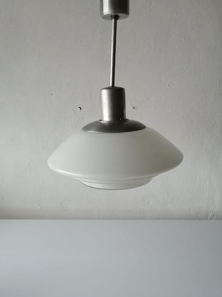 Layered milk glass Art Deco pendant lamp by VERALUX, 1940s, made in Germany 

Extremely rare and minimalist Bauhaus hanging light.

Lampshade is in good condition and very clean. 
Lamp has original metal canopy.
Wear consistent with use and