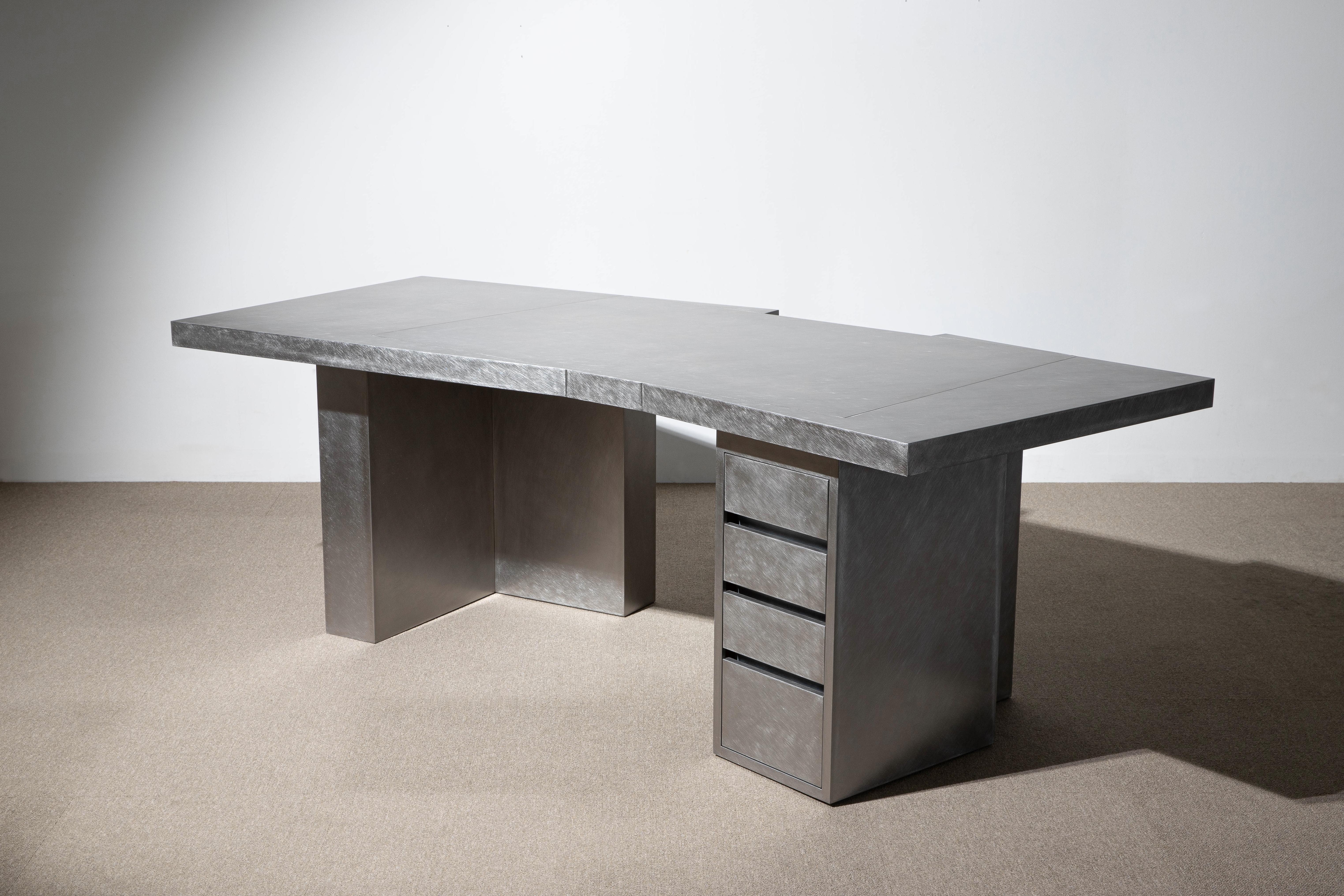 Layered steel desk by Hyungshin Hwang
Dimensions: D 230 x W 110 x H 75 cm
Materials: stainless steel

Layered Series is the main theme and concept of work of Hwang, who continues his experiment which is based on architectural composition of