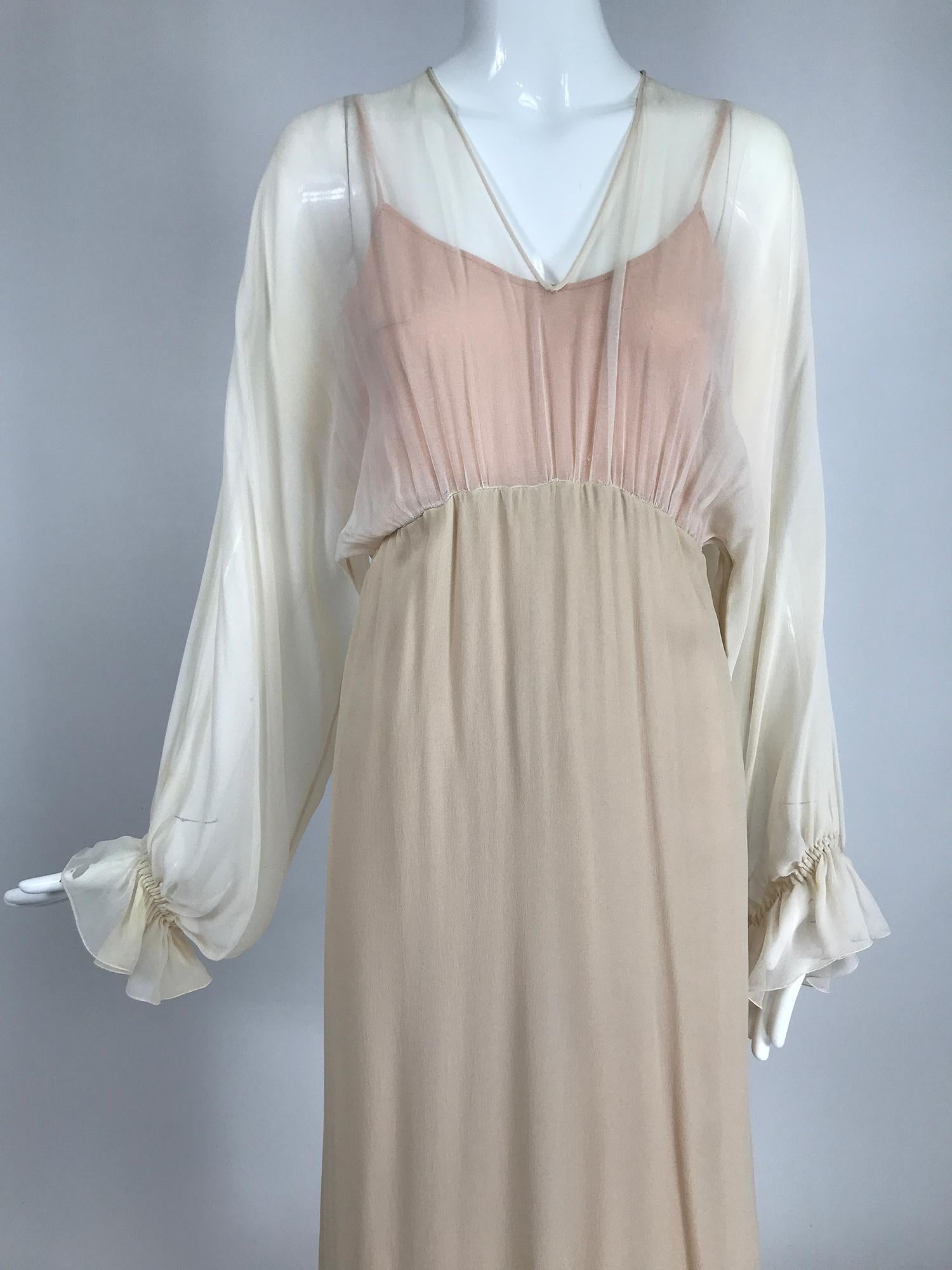     Tonal layered silk chiffon, bat wing, poet sleeve, maxi dress from the 1970s. This beautiful dress is done in tone on tone peachy/nude chiffon. The dress bodice has a V neckline and draped bat wing sleeves that are gathered into cased elastic