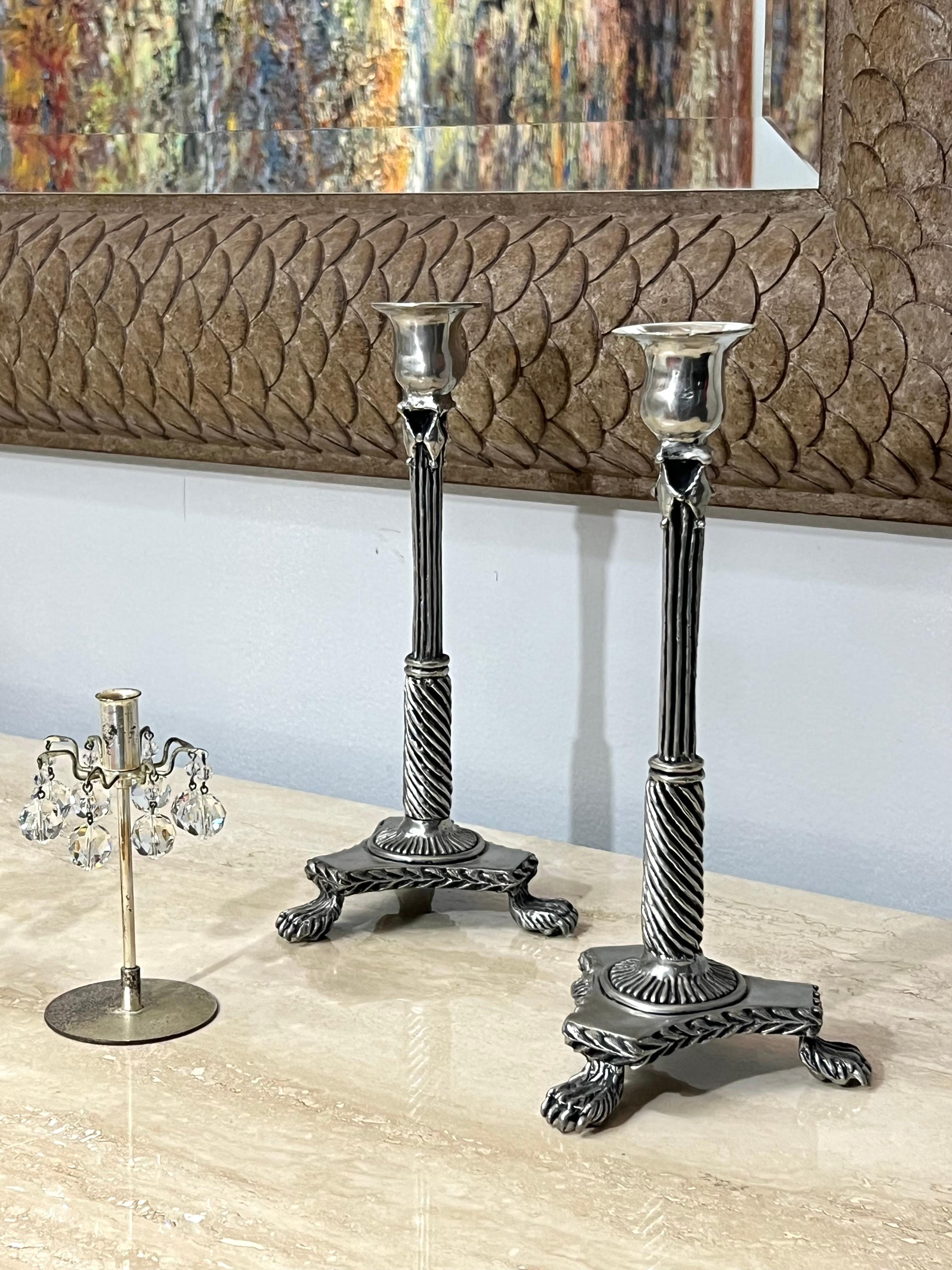 A pair of modern candlesticks with neoclassical detail. 