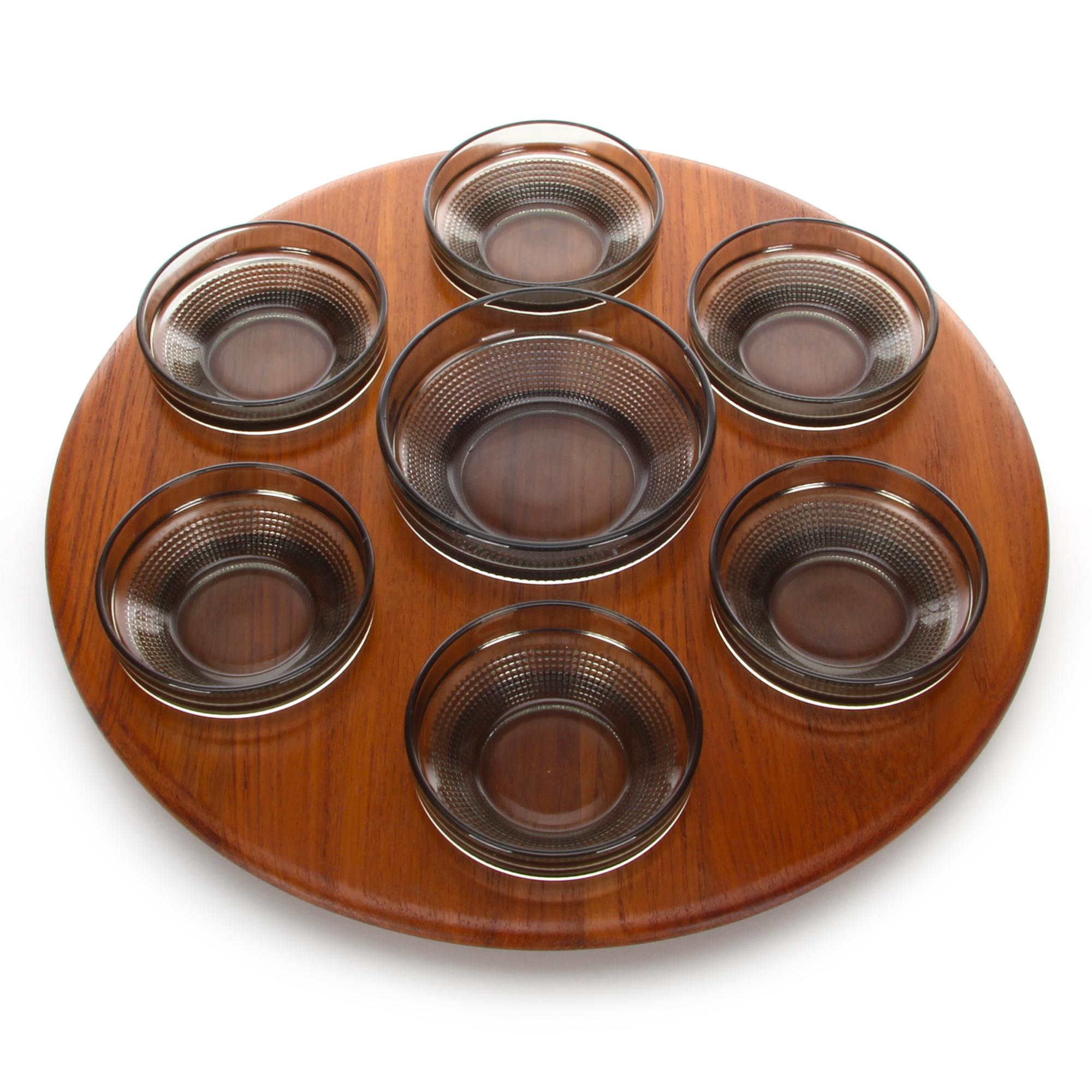 Lazy Susan, produced by Digsmed in 1964, Danish modern teak serving tray or platter, complete with seven original smokey glass bowls, in very good vintage condition.

A beautiful teak Lazy Susan featuring a soft rounded edge, circular indentations