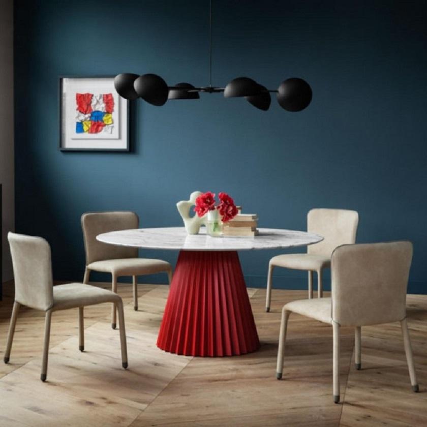 Fixed dining table with central lacquered metal base. Round top in marble 
In a slightly ironic way, this dining table pays homage to the world of fashion and the iconic pleated work,
Dimensions:
Width: 180 cm 70.87