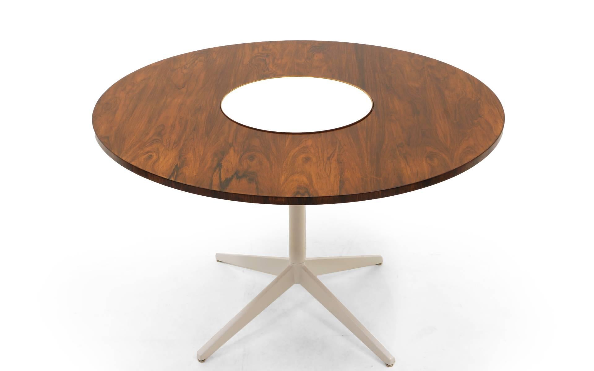 Early, rare rosewood lazy susan dining table designed by George Nelson for Herman Miller. The center white laminate area is a lazy susan so it turns in a circular motion. This is the only example we have ever seen with a rosewood top. 
Lazy Susan
