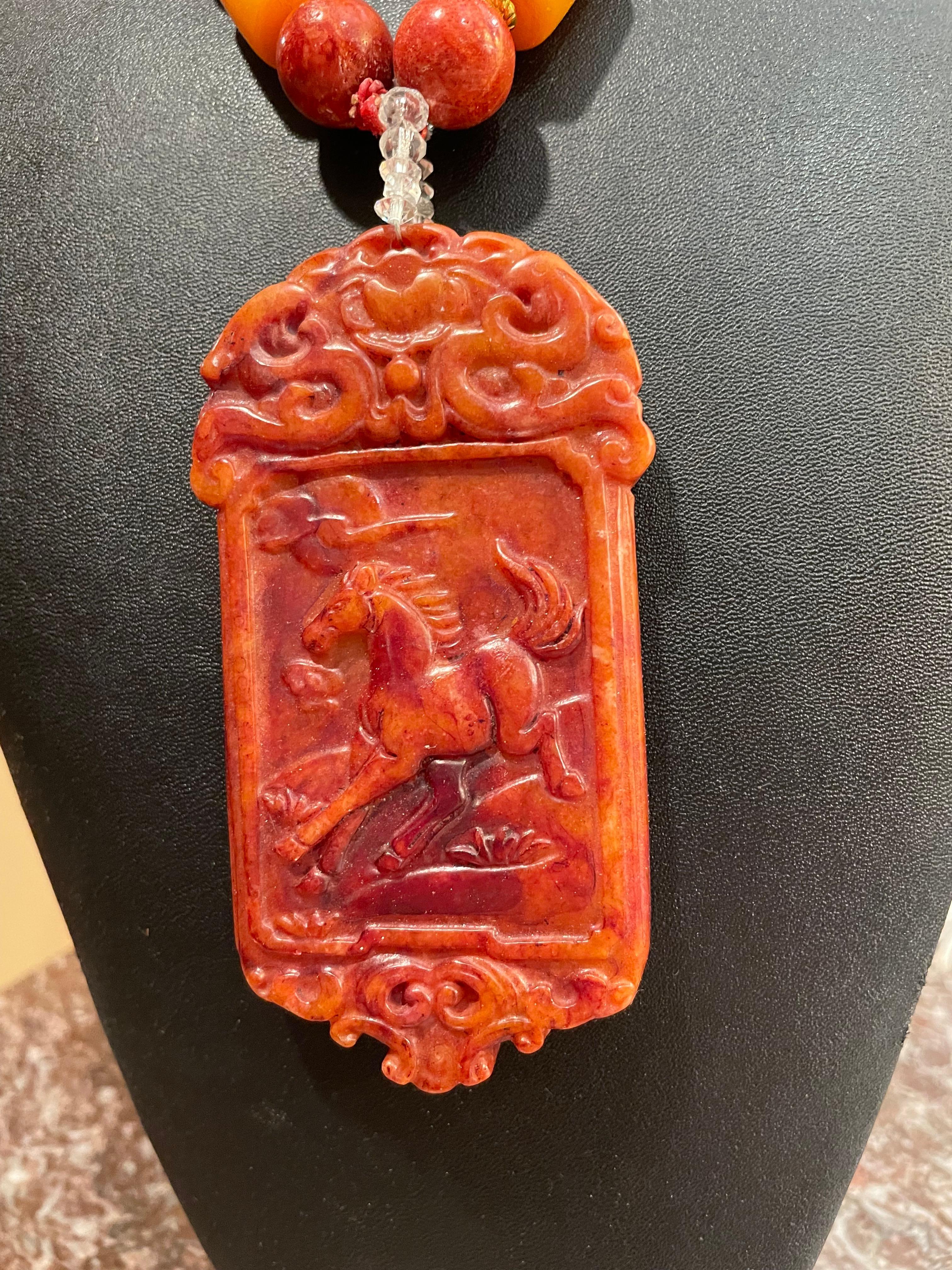 LB Chinese soapstone carved horse motif pendant on a one of a kind , handmade, statement necklace. This piece makes a stunning statement about the wearer and will be a conversation starter wherever it goes. The wonderful warm colors will enhance all