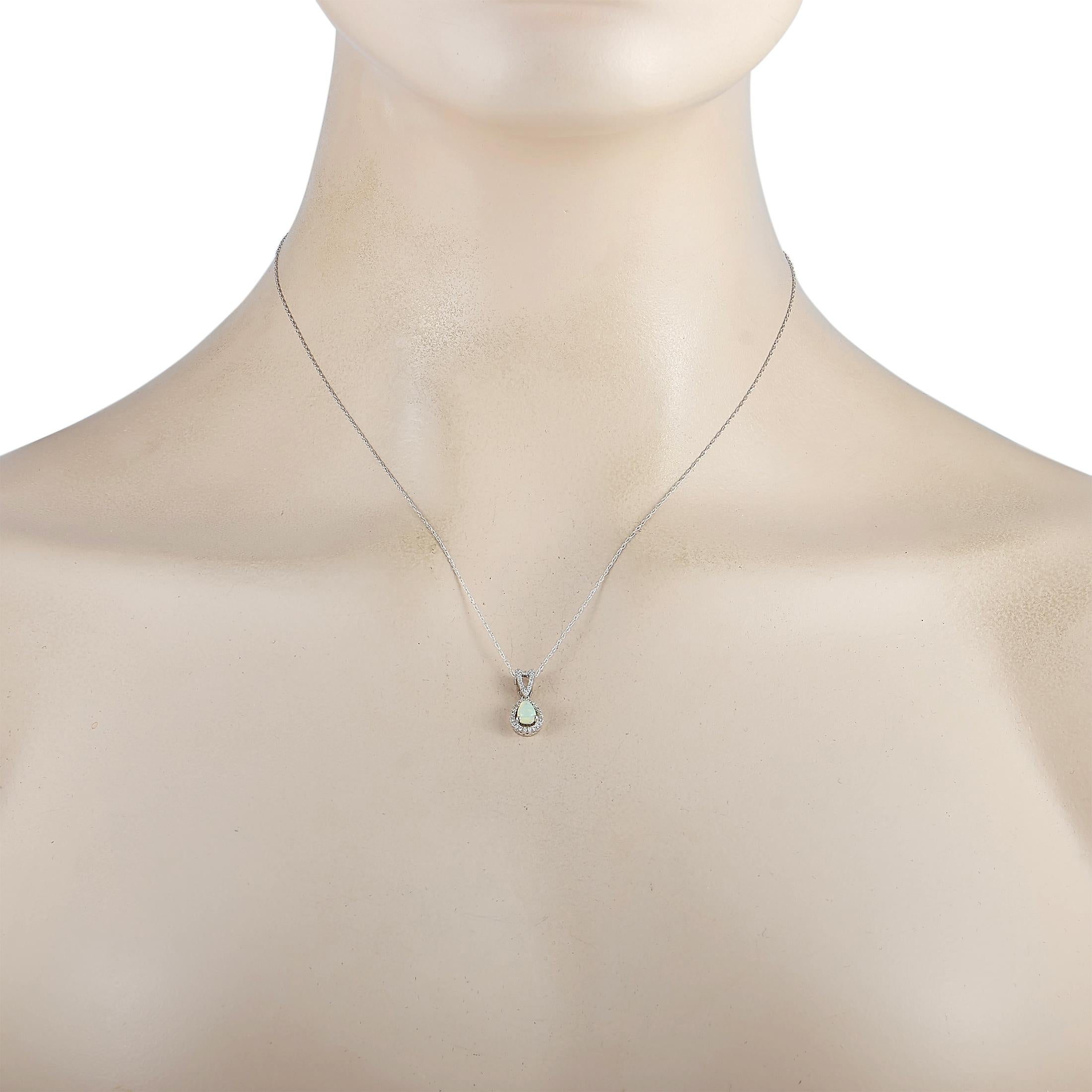 This LB Exclusive necklace is crafted from 14K white gold and weighs 1.6 grams. It is presented with a 17” chain and a pendant that measures 0.70” in length and 0.30” in width. The necklace is embellished with an opal and a total of 0.11 carats of