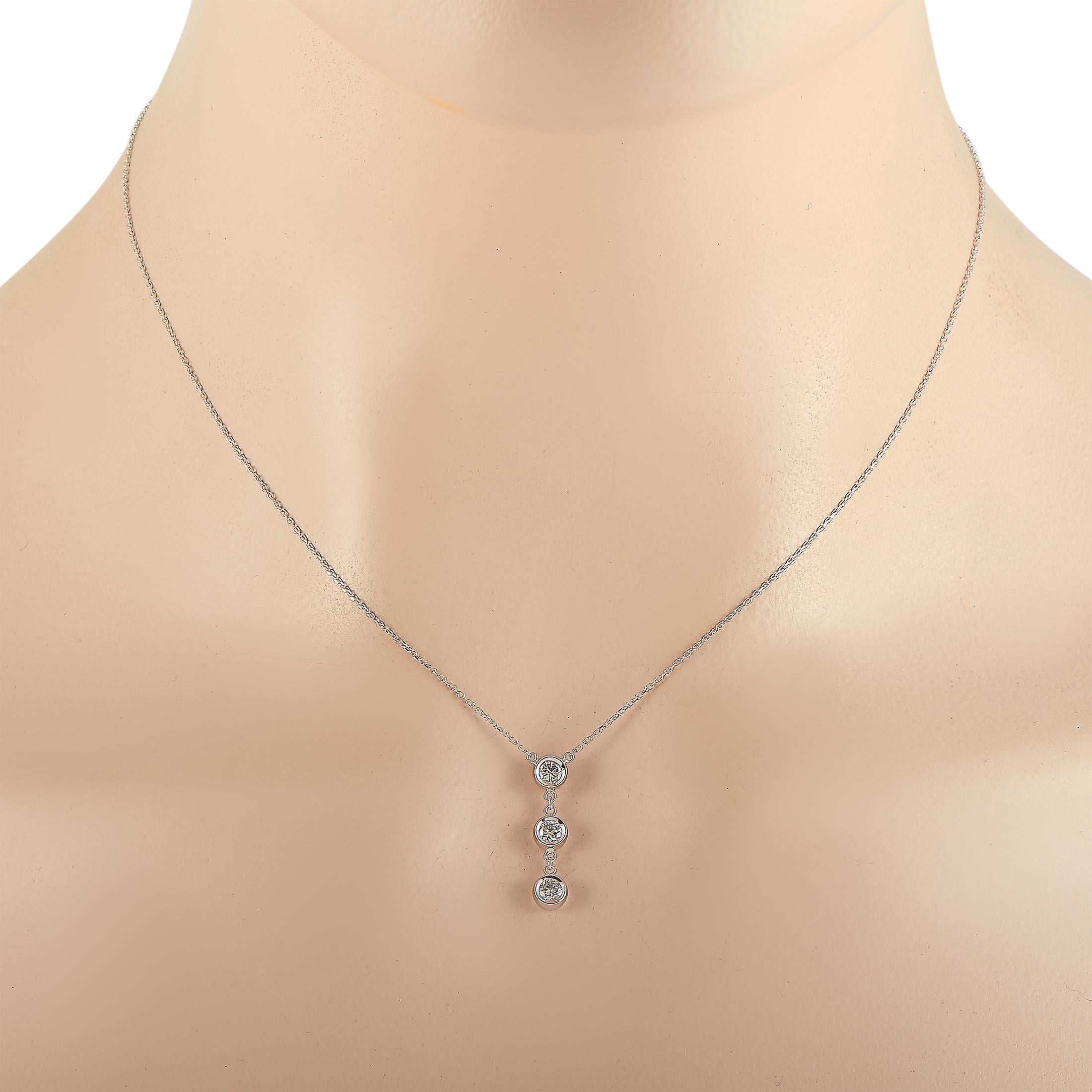This LB Exclusive necklace is crafted from 14K white gold and weighs 1.9 grams. It is presented with a 16” chain and boasts a pendant that measures 0.75” in length and 0.15” in width. The necklace is set with diamonds that total 0.35 carats.
 
