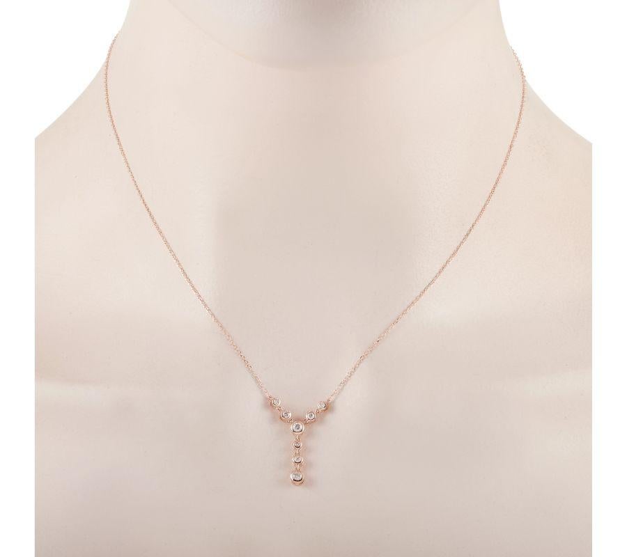 This LB Exclusive necklace is crafted from 14K rose gold and weighs 2.2 grams. It is presented with a 15” chain and boasts a pendant that measures 1” in length and 0.50” in width. The necklace is set with diamonds that total 0.25 carats.
 

