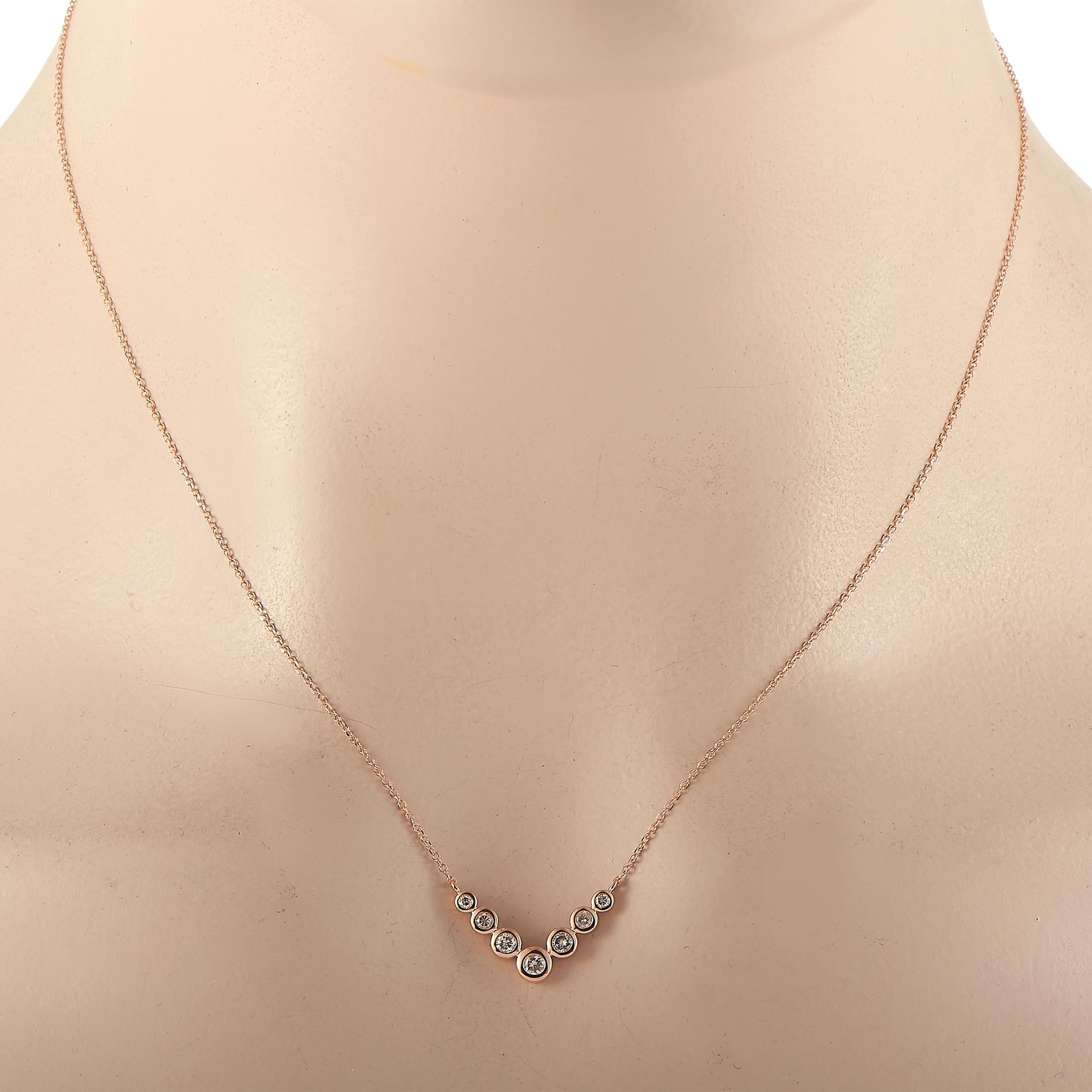 This LB Exclusive necklace is crafted from 14K rose gold and weighs 2 grams. It is presented with a 16” chain and boasts a pendant that measures 0.50” in length and 0.75” in width. The necklace is set with diamonds that total 0.25 carats.
 
 Offered