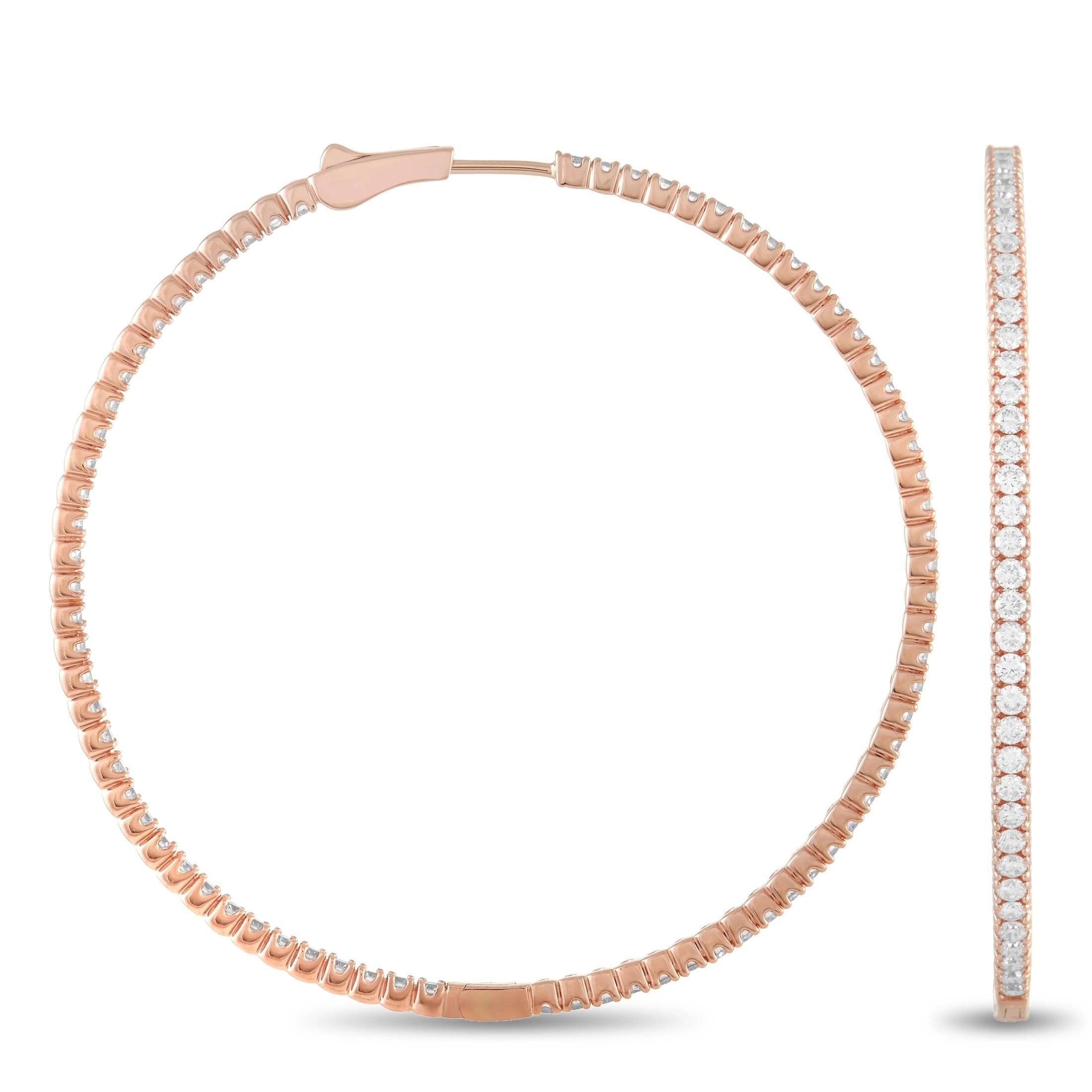 Every inch of these elegant hoop earrings sparkles and shines thanks to a glittering array of diamonds with a total weight of 4.14 carats. Each earring measures 2” round and includes a breathtaking 14K Rose Gold setting. 
 
 This jewelry piece is