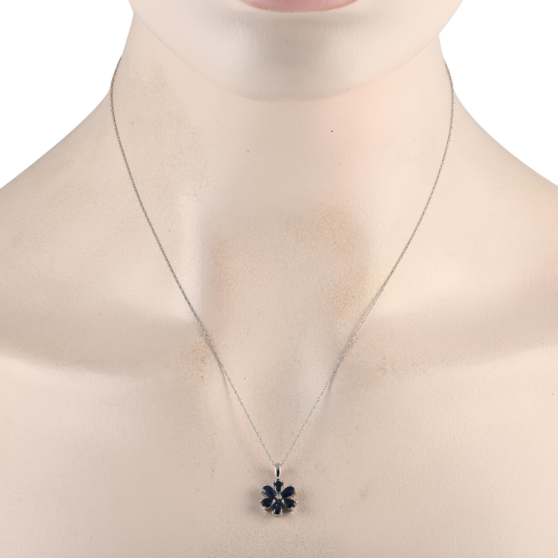 A floral pendant measuring 0.75 long by 0.50 wide makes this impeccably crafted necklace simply unforgettable. Deep blue sapphire petals elevate the 14K white gold pendant, while a singular 0.01ct diamond center stone provides the perfect finishing