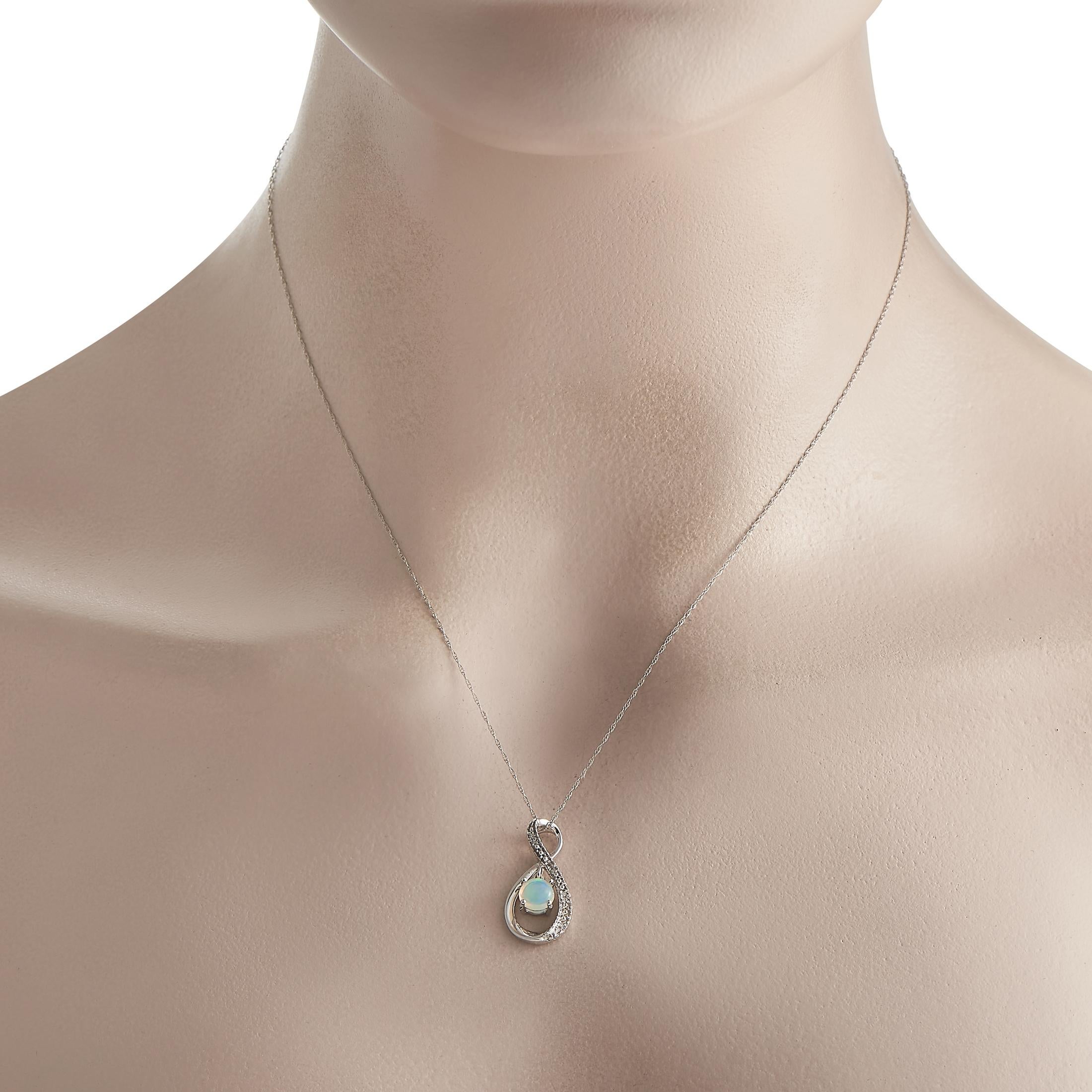 This white gold necklace fascinates with its brilliant display of spectral colors. It holds an opal gem, the October birthstone, that plays with light and gives off a rainbow of beauty. The slim, double cable chain neckalce measures 18 inches long