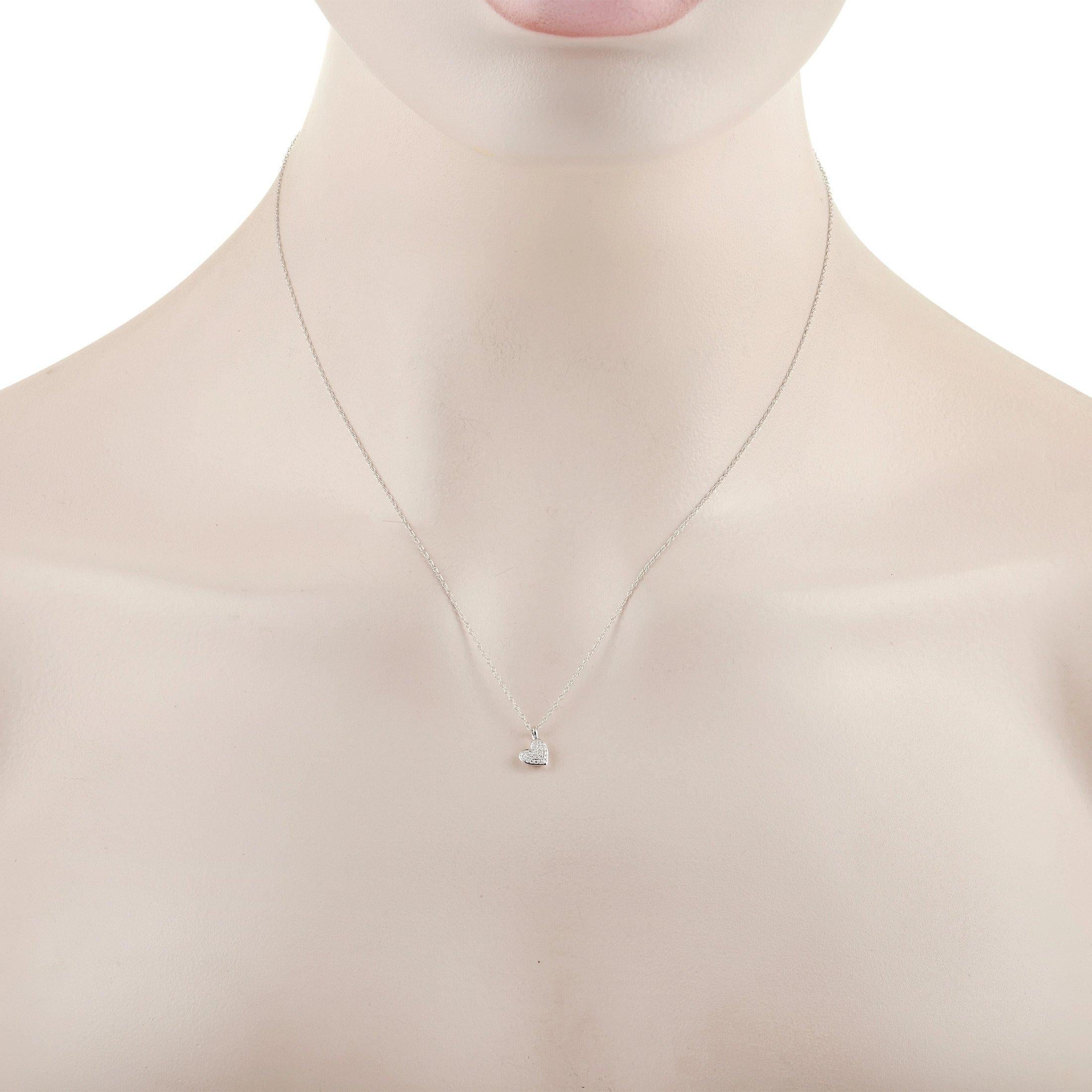 This elegant LB Exclusive 14K White Gold 0.06 ct Diamond Heart Necklace is made with a delicate 14K white gold chain, highlighting a small 14k white gold heart pendant. The heart is set with a cluster of round-cut diamonds totalling 0.06 carats over