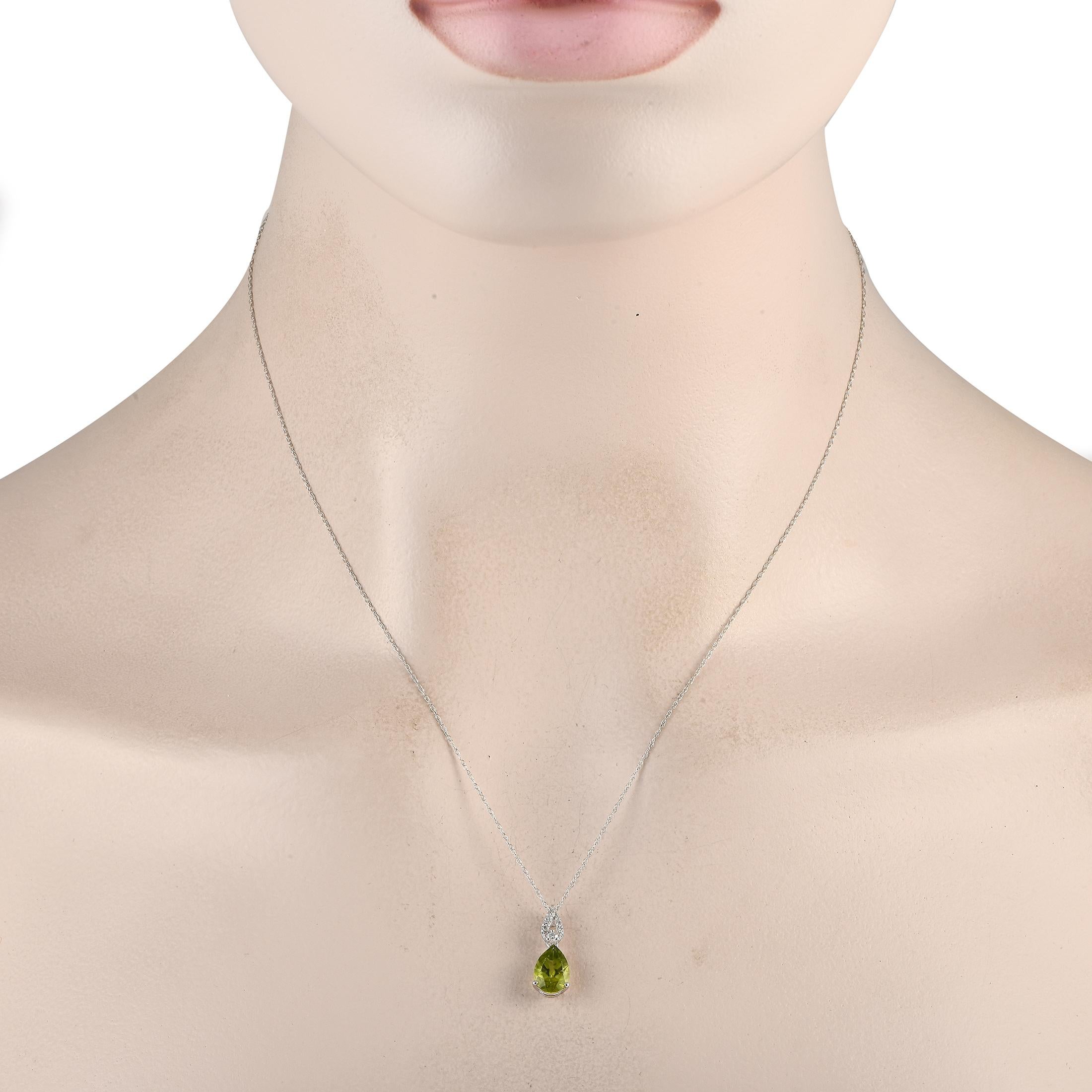 You can't go wrong with gold and diamonds with a hint of color. This LB Exclusive piece features a delicate chain necklace measuring 18 inches long. Its link-style bail is traced with diamonds and it holds a bright and beautiful pear-cut peridot.