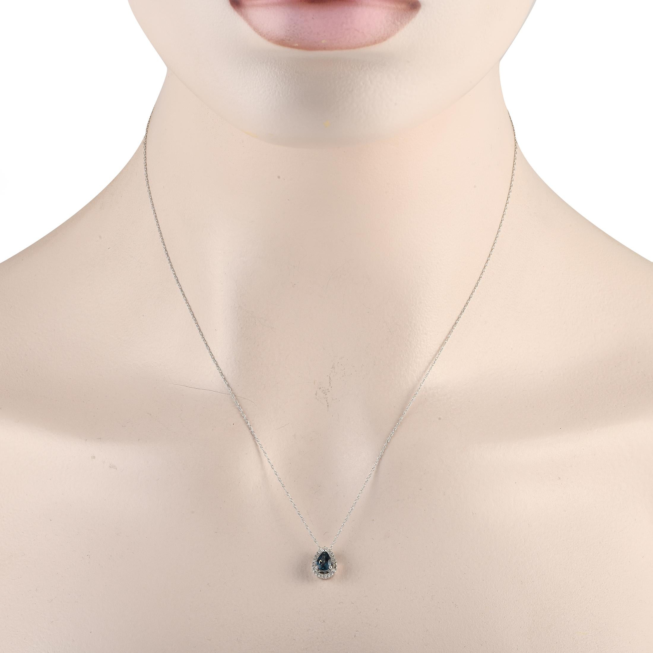 A pear-shaped blue topaz gemstone serves as a stunning focal point on this stylish luxury necklace. Incredibly elegant, this piece features a 14K white gold pendant measuring 0.45 long by 0.25 wide suspended from an 18 chain. Diamonds with a total