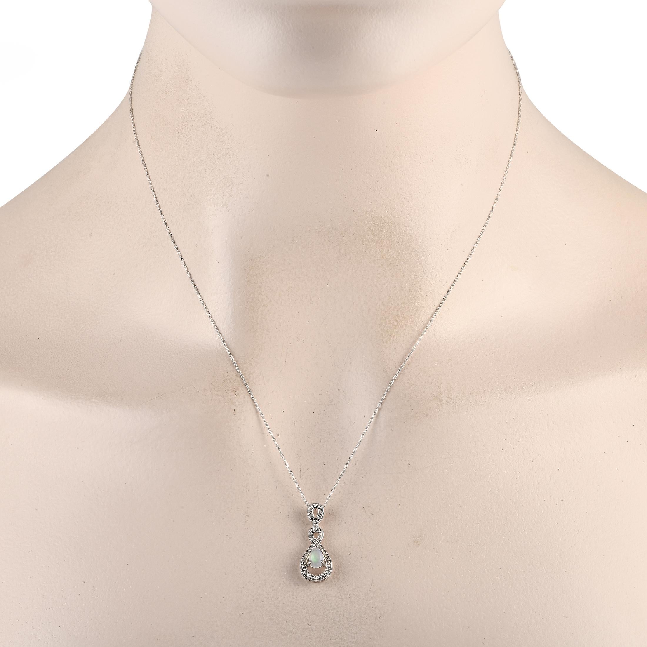 A fiery Opal center stone adds color and dimension to this elegant, understated necklace. On this pieces intricate 14K White Gold pendant  which measures 0.85 long by 0.45 wide  additional Diamond accents totaling 0.08 carats provide the perfect
