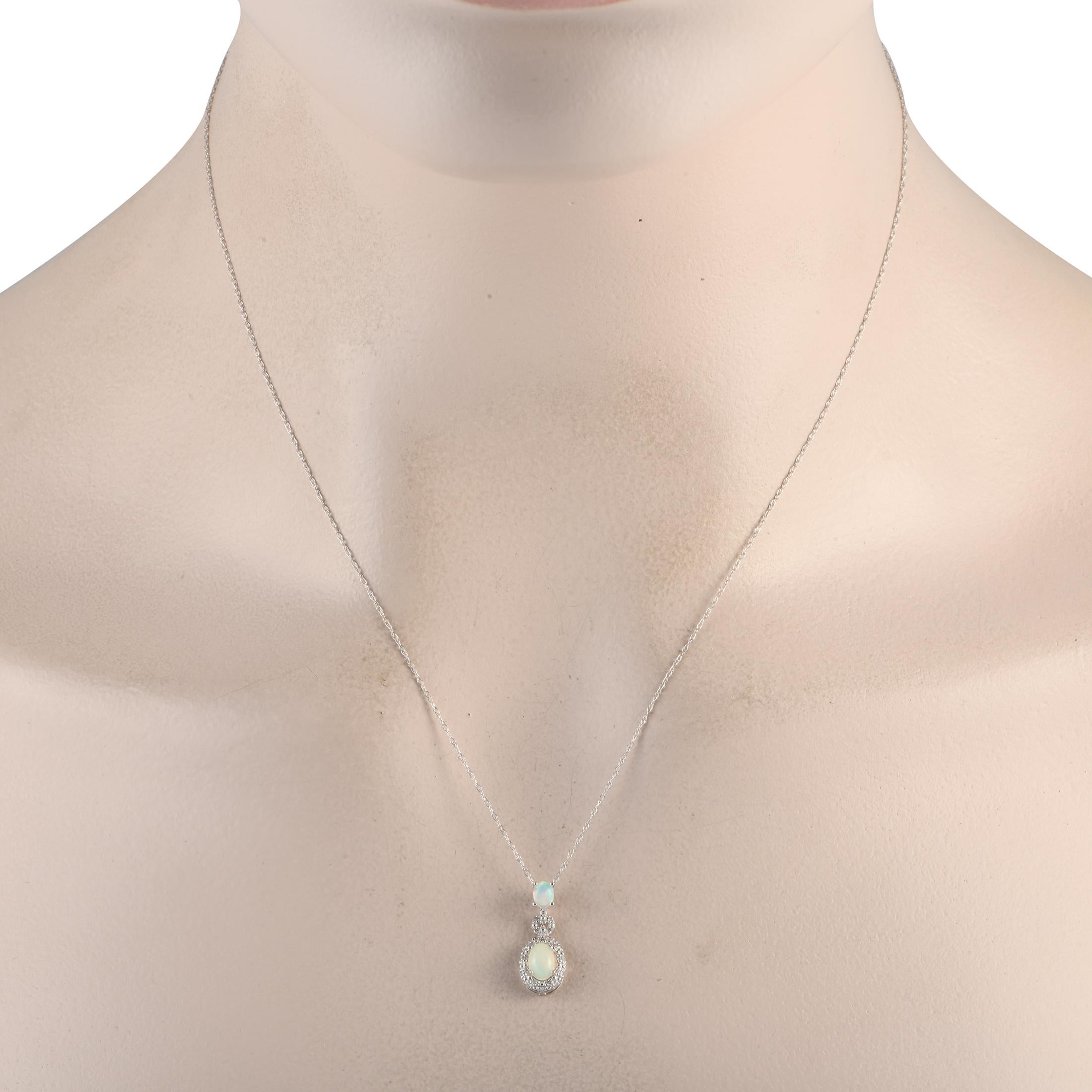 This luxurious necklace is incredibly sophisticated. Suspended from an 18 chain, youll find an elegant 14K white gold pendant measuring 0.75 long by 0.25 wide. A pair of radiant opals elevate this dynamic design, while sparkling diamonds totaling
