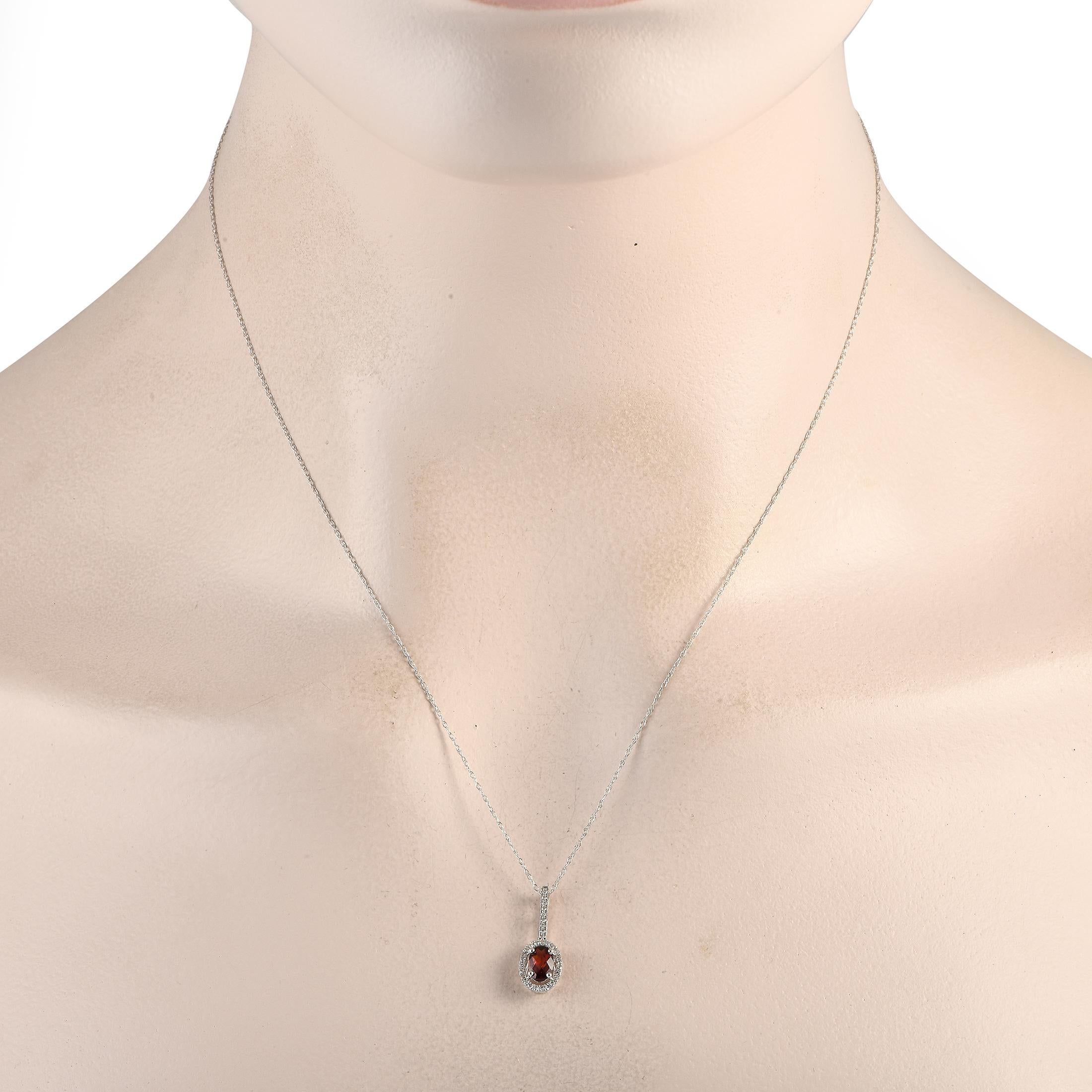 This 14K White Gold necklace will continually make a subtle statement. Suspended from an 18 chain, youll find a sleek pendant measuring 0.75 long by 0.25 wide. It makes a statement thanks to a stunning Garnet center stone and sparkling Diamond