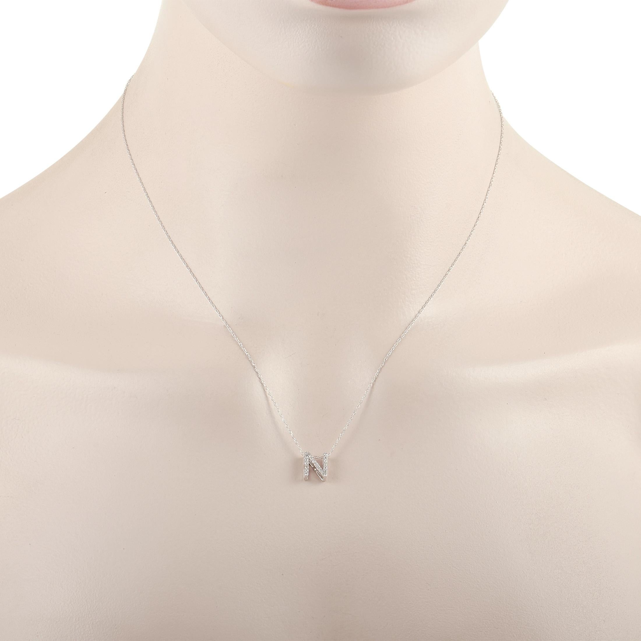 This pretty LB Exclusive 14K White Gold 0.10 ct Diamond Initial ‘N’ Necklace is made with a delicate 14K white gold chain and features a small white gold pendant shaped like the letter ‘N’ and set with 0.10 carats of round diamonds throughout. The
