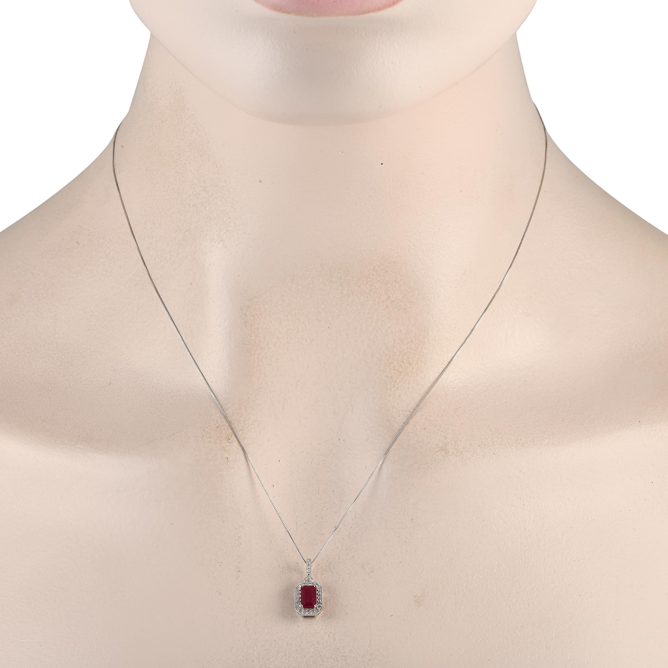 A ruby center stone serves as a striking focal point on this impeccably crafted necklace. Simple and elegant, this piece features a 14K white gold pendant measuring 0.65 long by 0.25 wide suspended from an 18 chain. Diamonds with a total weight of
