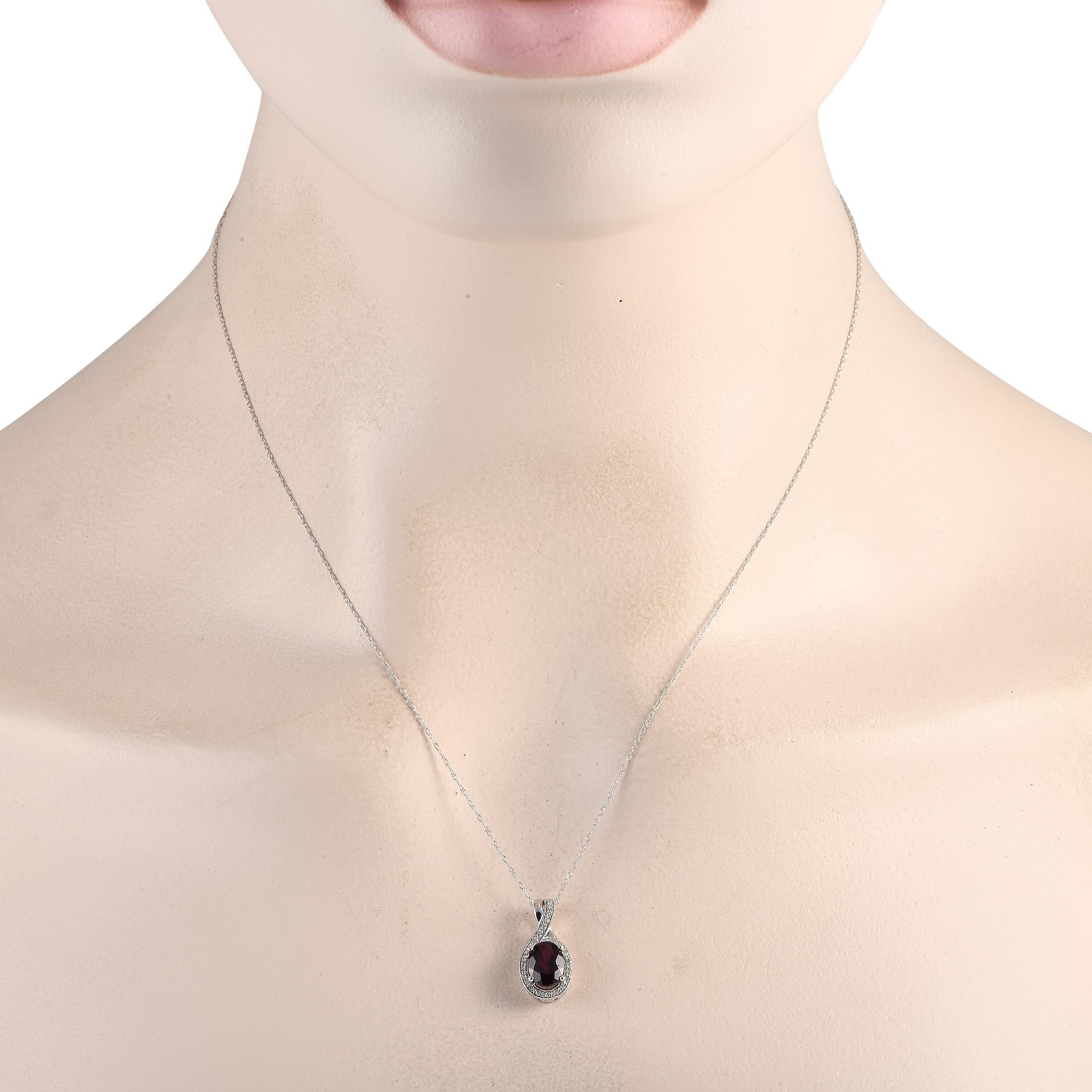 At the center of this necklaces elegant 14K White Gold pendant, a captivating Garnet center stone shines to life thanks to additional Diamond accents totaling 0.11 carats. The pendant measures 0.75 long by 0.45 wide and is suspended from an 18