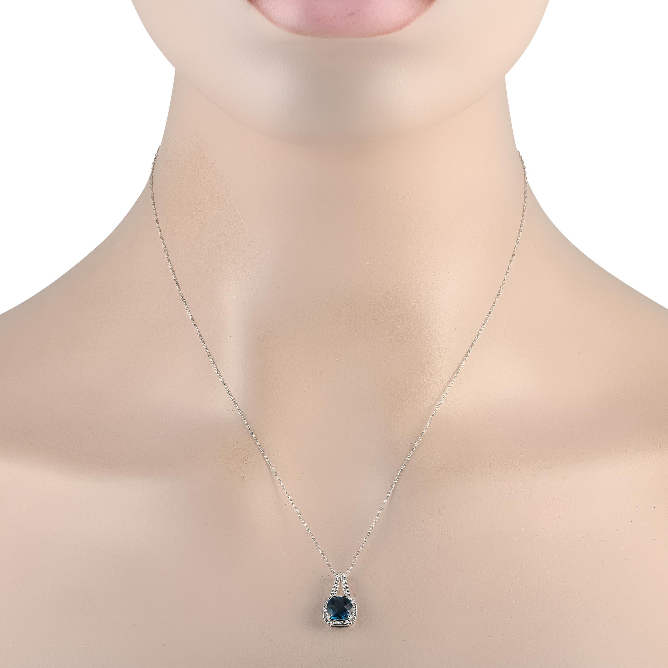 Offering style and sophistication, this gemstone necklace will give any ensemble a radiant polish. The necklace is crafted in 14K white gold and has a spring ring clasp. It holds a blue topaz pendant surrounded by a cushion-shaped frame of round