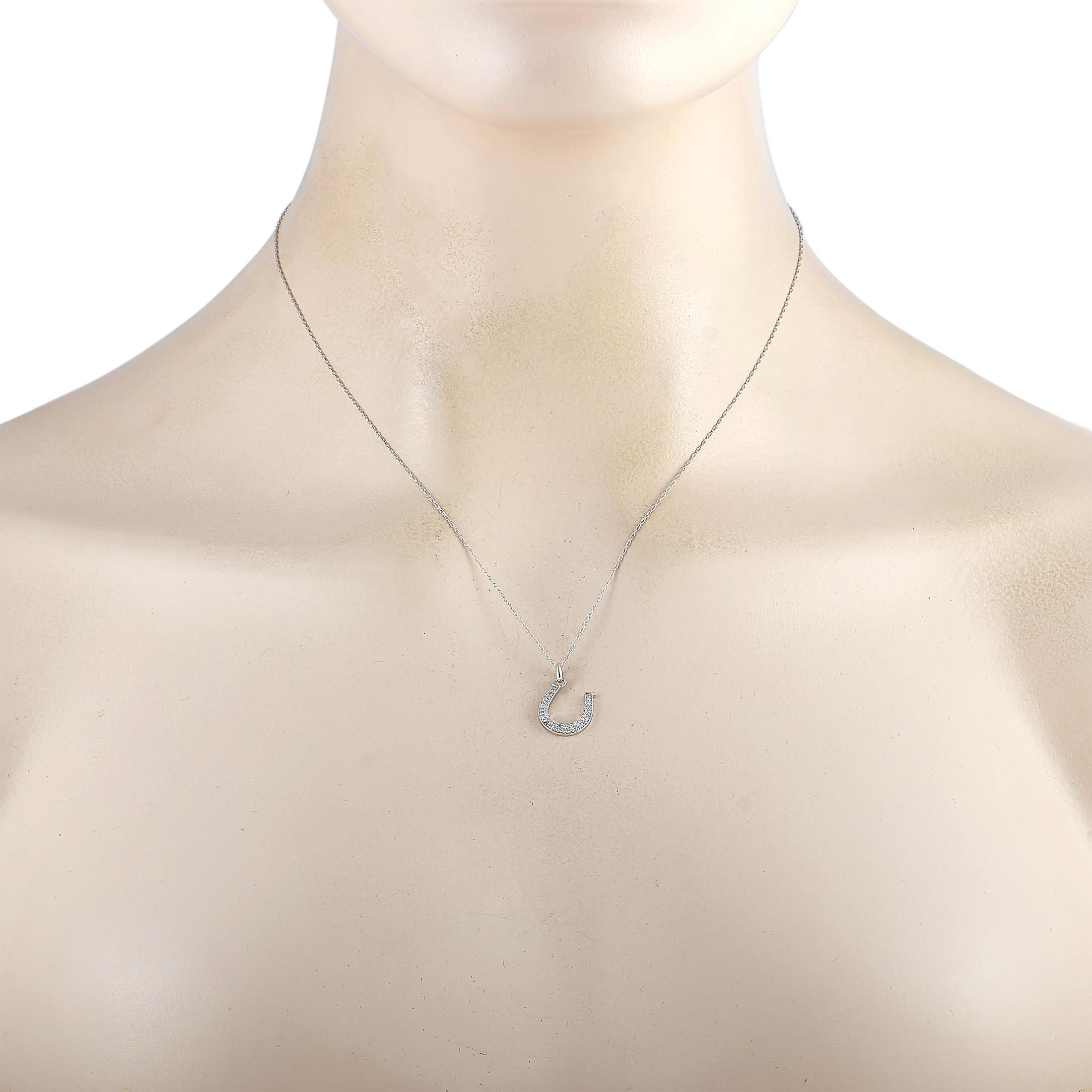 This LB Exclusive necklace is crafted from 14K white gold and weighs 1.5 grams. It is presented with a 17.50” chain and a horsebit pendant that measures 0.62” in length and 0.47” in width. The necklace is embellished with diamonds that total 0.14