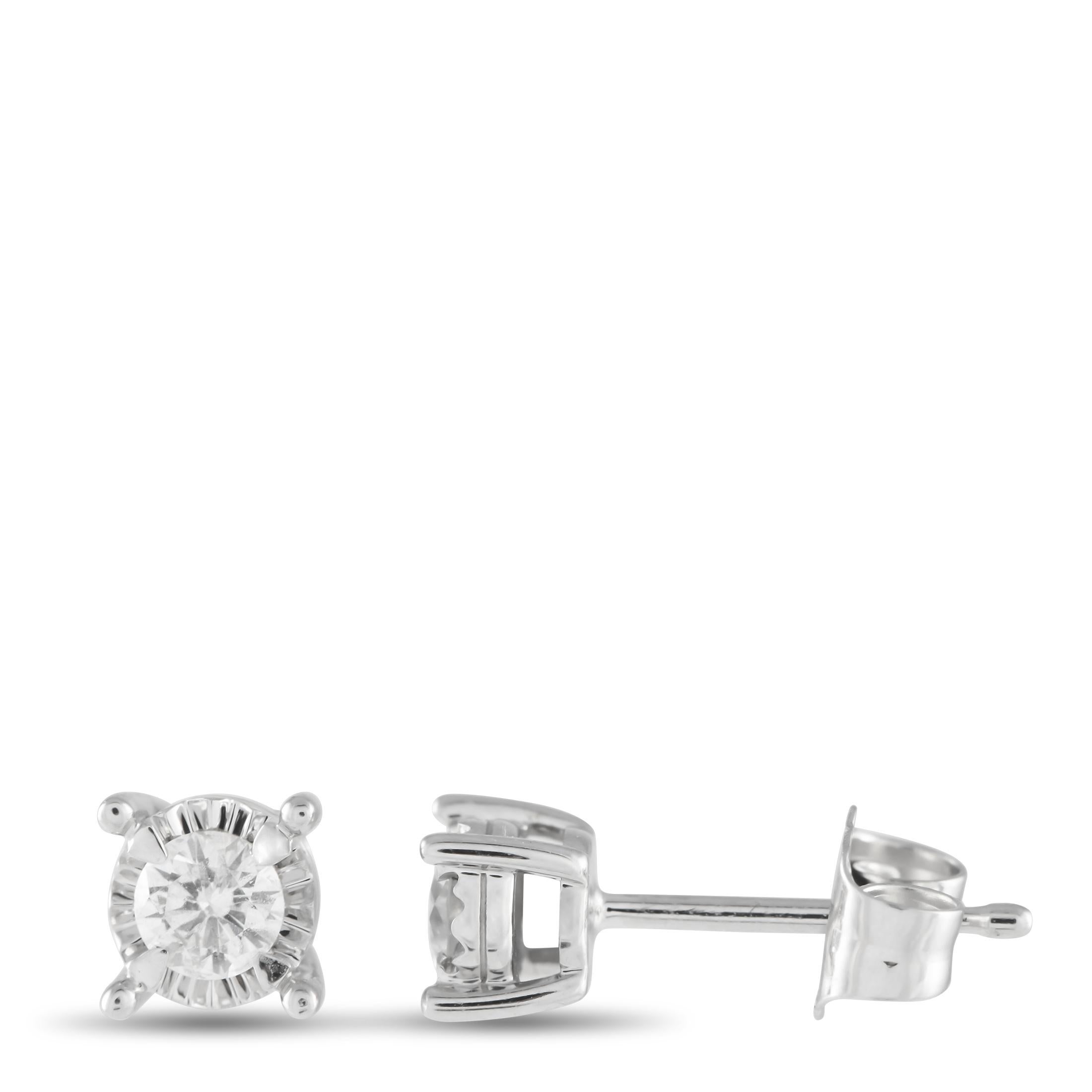 Simple Diamond solitaires shine brightly from their place within a textured 14K White Gold setting on these impeccably crafted earrings. The perfect way to add a touch of luxury to any occasion, together they possess a total wight of 0.14 carats.