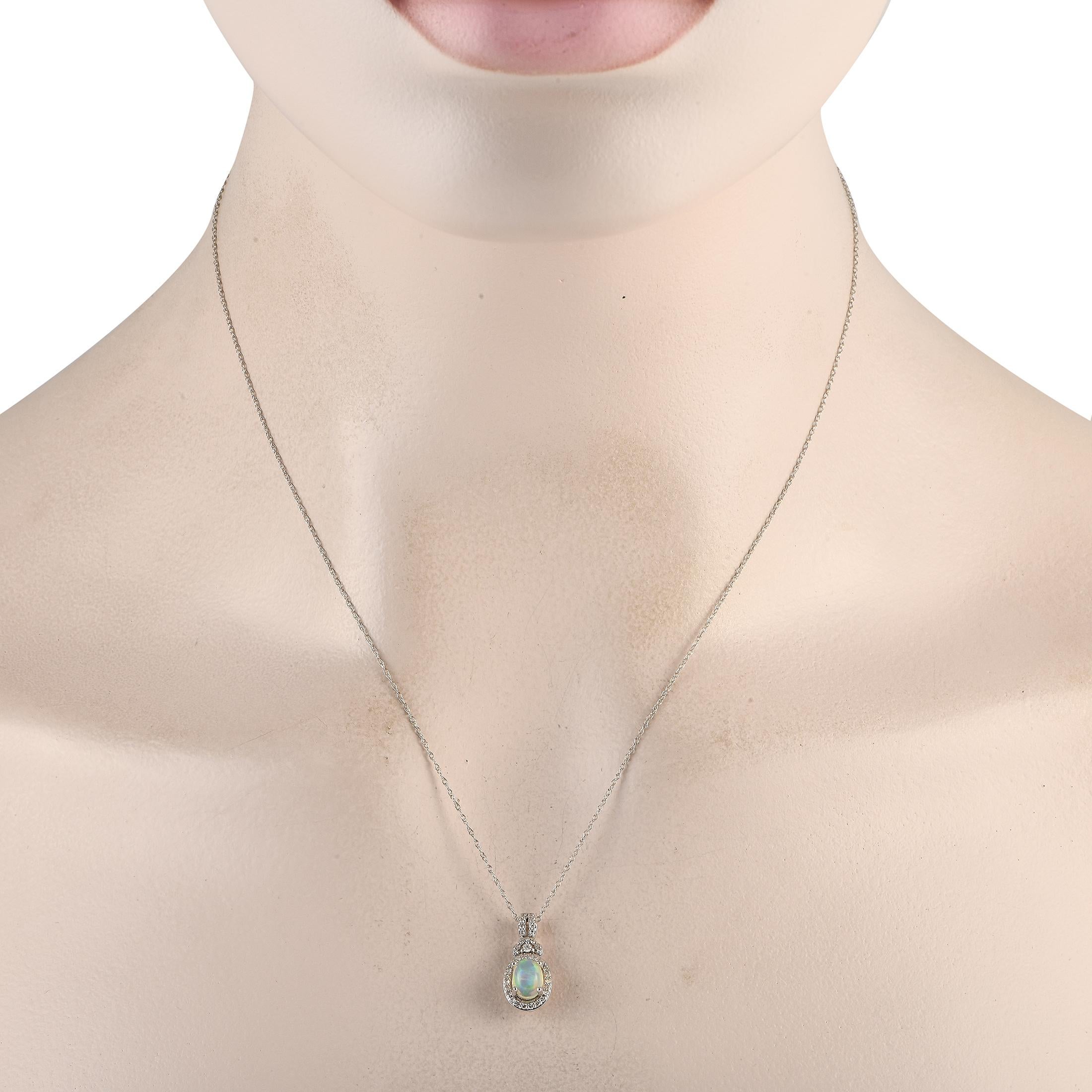 Highlight your necklace and bring a touch of glamour to your looks with this white gold necklace punctuated by a milky white opal. The necklace chain measures 18 inches long. It holds a diamond-traced pendant with an oval-shaped opal gemstone framed