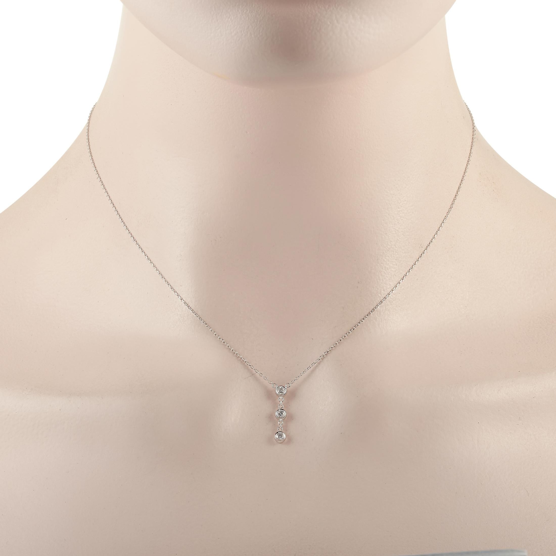 This LB Exclusive necklace is crafted from 14K white gold and weighs 1.4 grams. It is presented with a 15” chain and boasts a pendant that measures 0.68” in length and 0.13” in width. The necklace is set with diamonds that total 0.15 carats.
 
