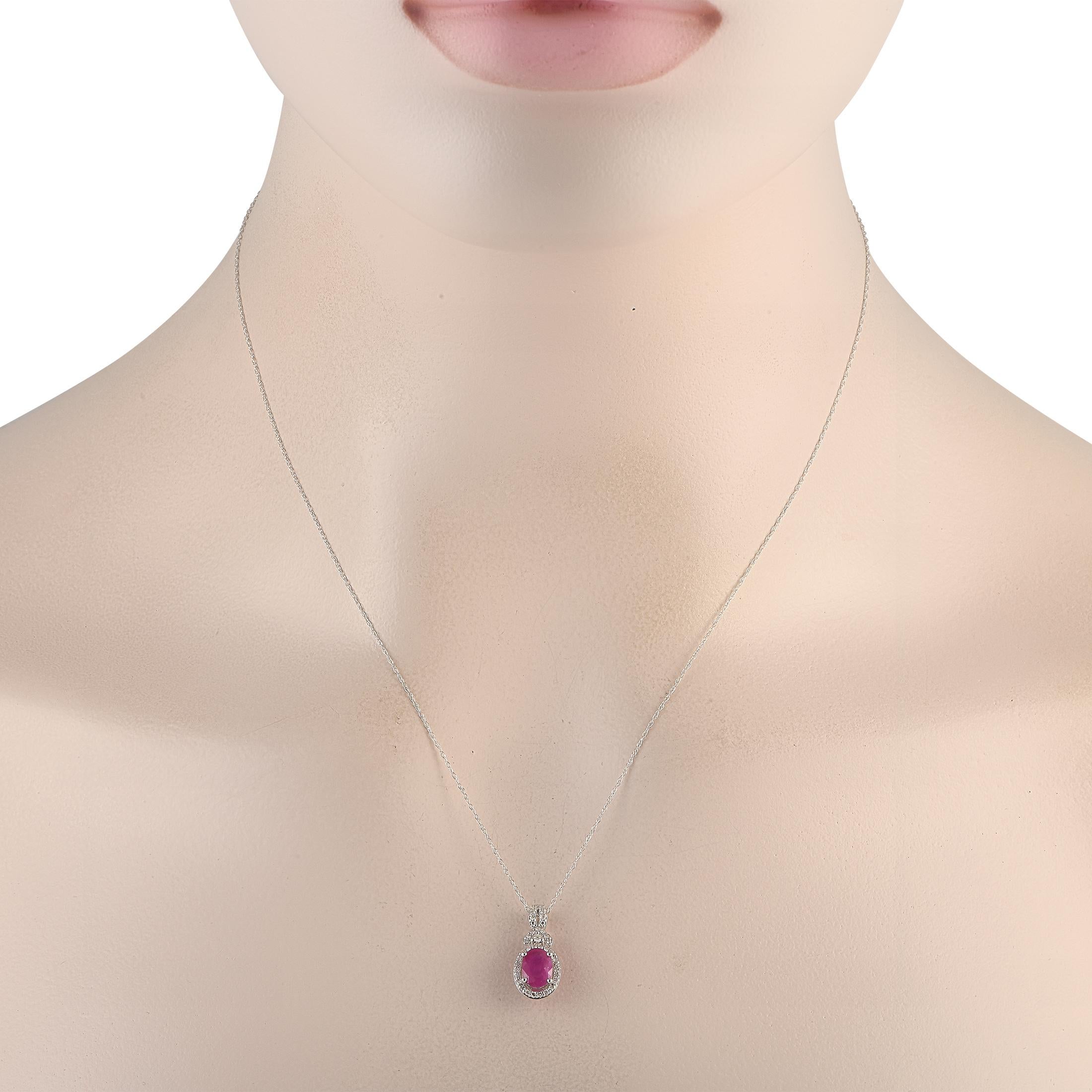 An intricate 14K White Gold pendant measuring 0.75 long and 0.35 wide serves as a stunning focal point on this simple, elegant necklace. The pendants charming Ruby center stone comes to life thanks to a dazzling array of Diamonds with a total weight