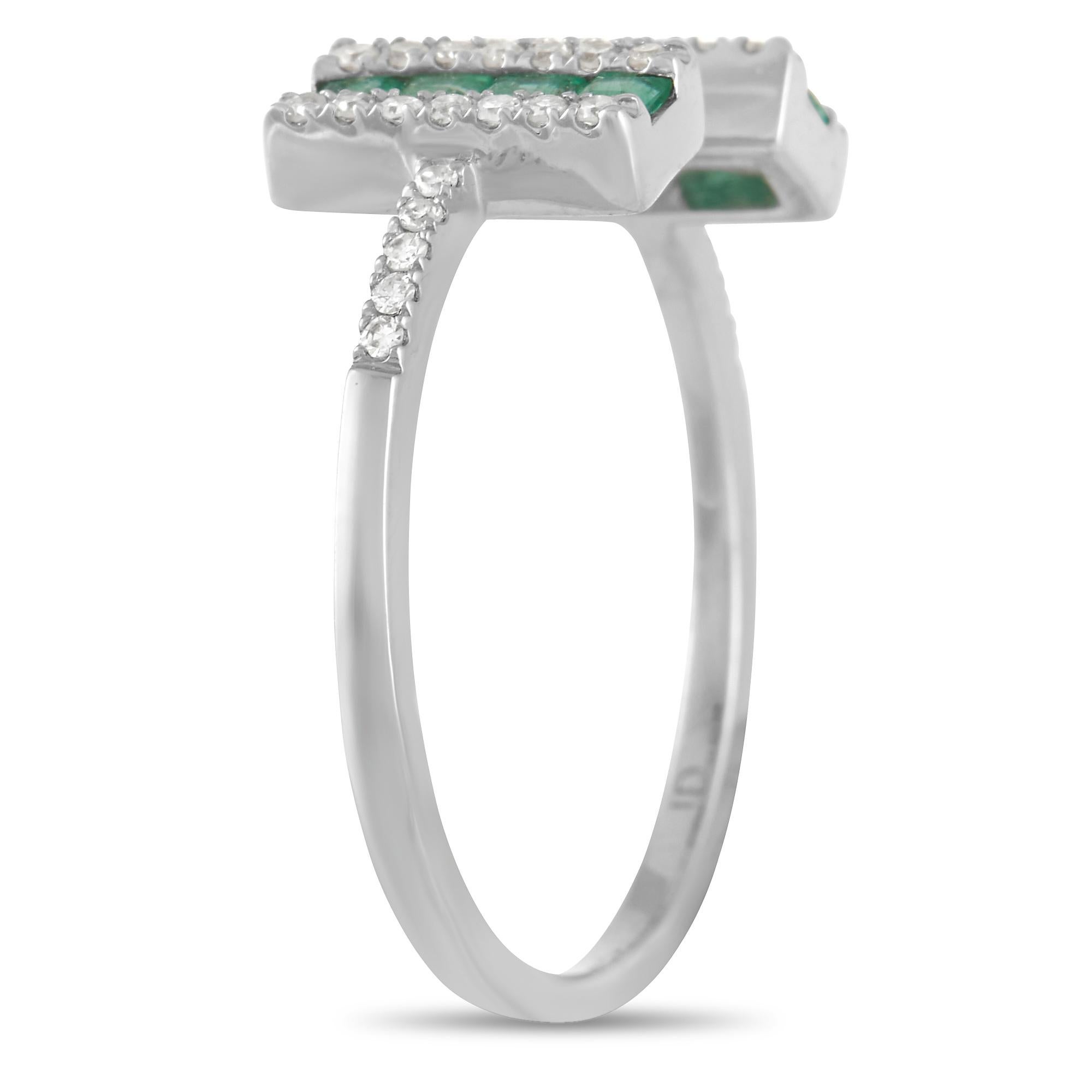 This elegant ring is simple and sophisticated all at once. The 14K White Gold setting comes to life thanks to the bold negative space at the center and captivating green emeralds. Adorned with diamonds totaling 0.16 carats, this piece features a 1mm