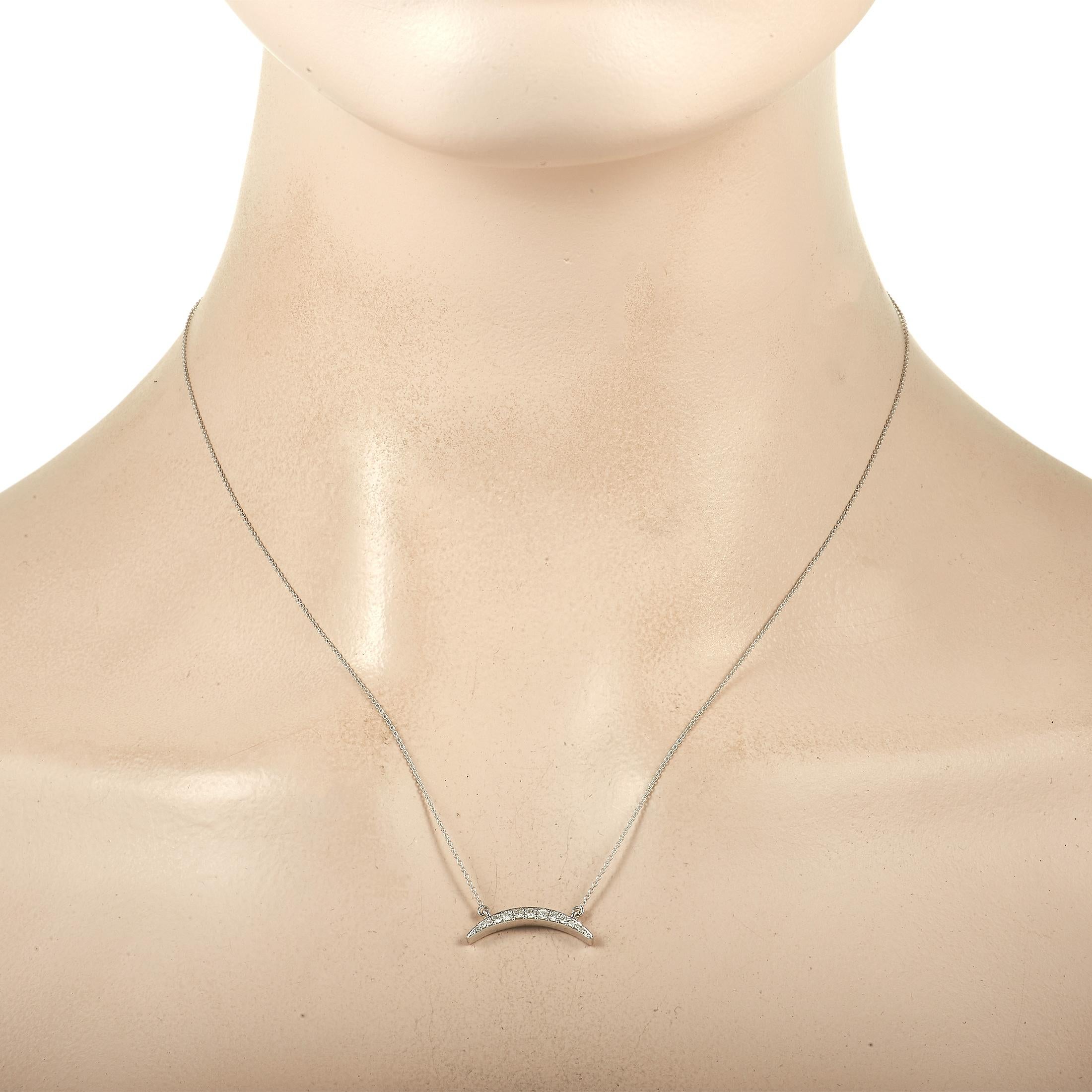 This minimalist pendant necklace is chic and sophisticated. This piece’s crescent-shaped pendant measures 0.75” long, 0.07” wide, and is covered in diamonds with a total weight of 0.16 carats. Crafted from 14K White Gold, it’s suspended in the