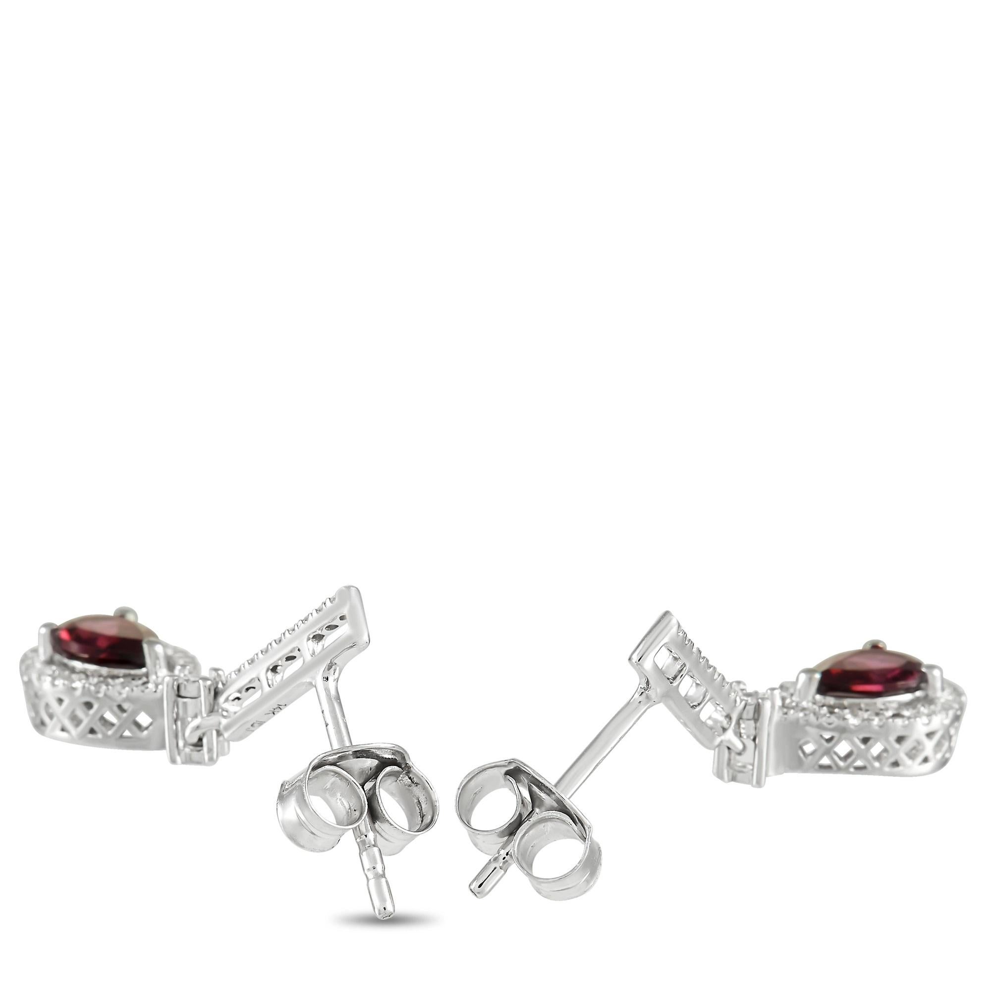 These gorgeous LB Exclusive earrings are a must-have. The pair is made with 14K White Gold and set with round-cut diamonds over the face of each earring, highlighting a beautiful pear-cut garnet stone set in the center of the drop. The earrings have
